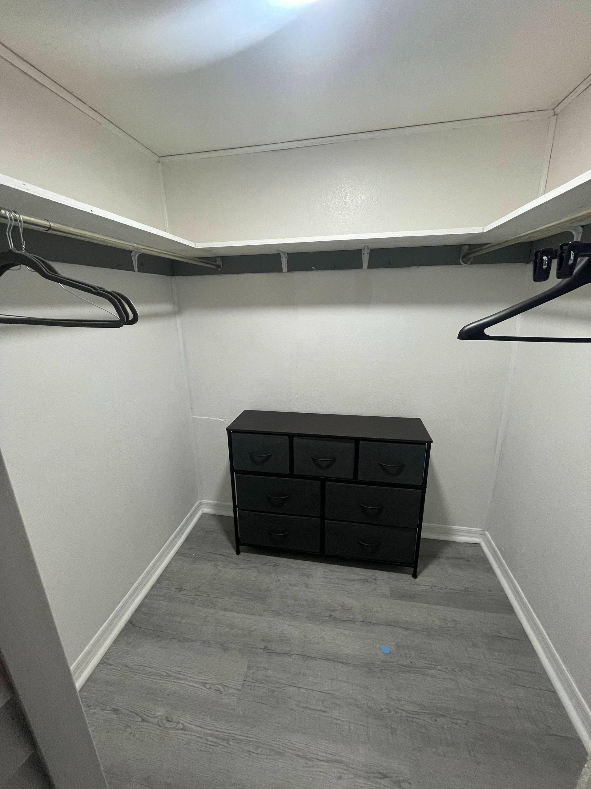 Walk in closet with shelves and extra 6 drawer dresser