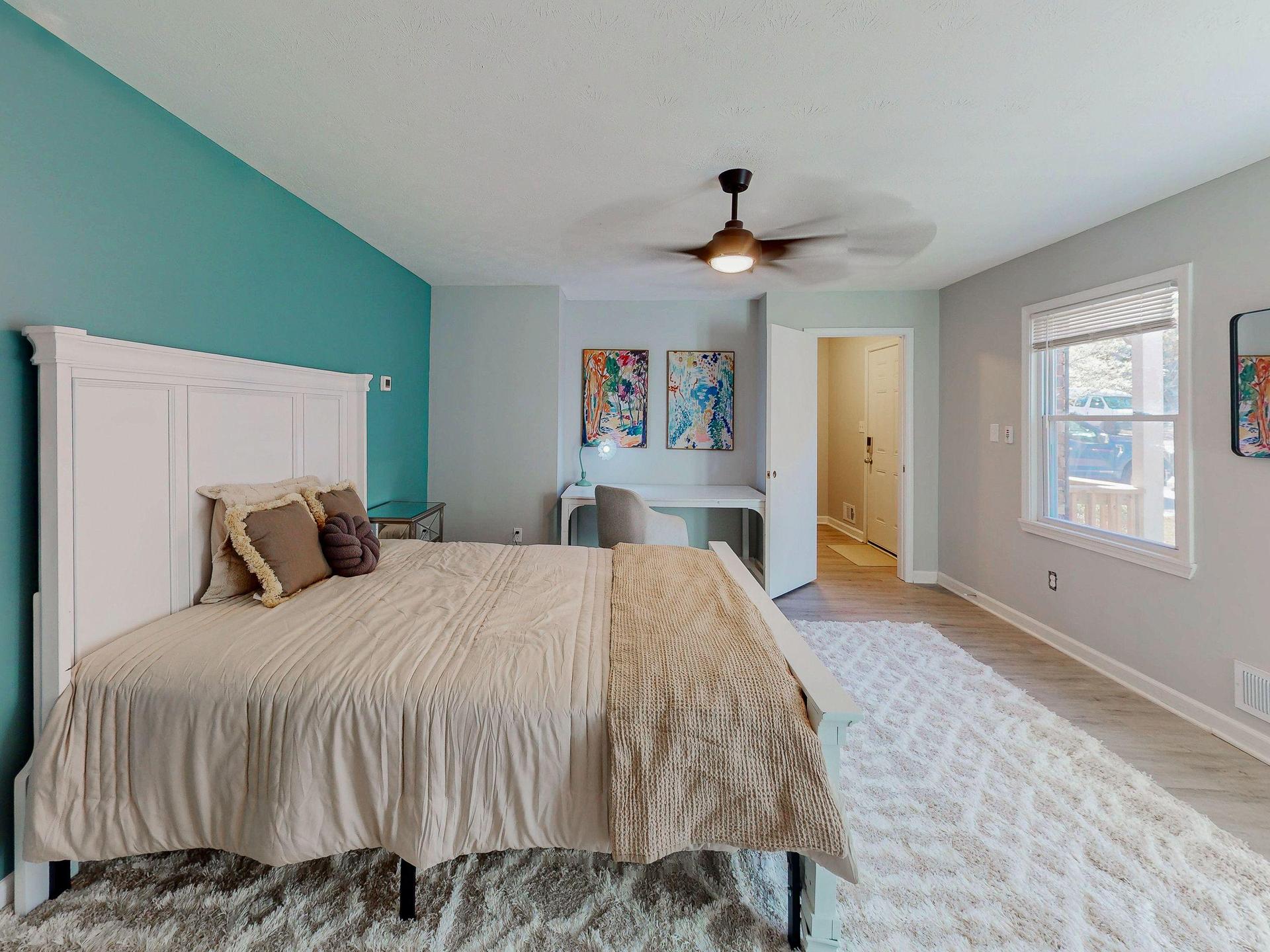 Light and bright large bedroom area with queen bed, executive desk, desk chair and ceiling fan provided and all brand new