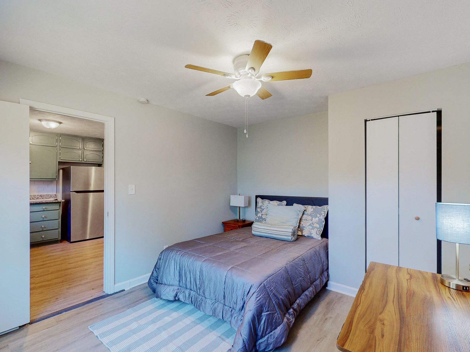 Cozy space with ceiling fan and full size bed