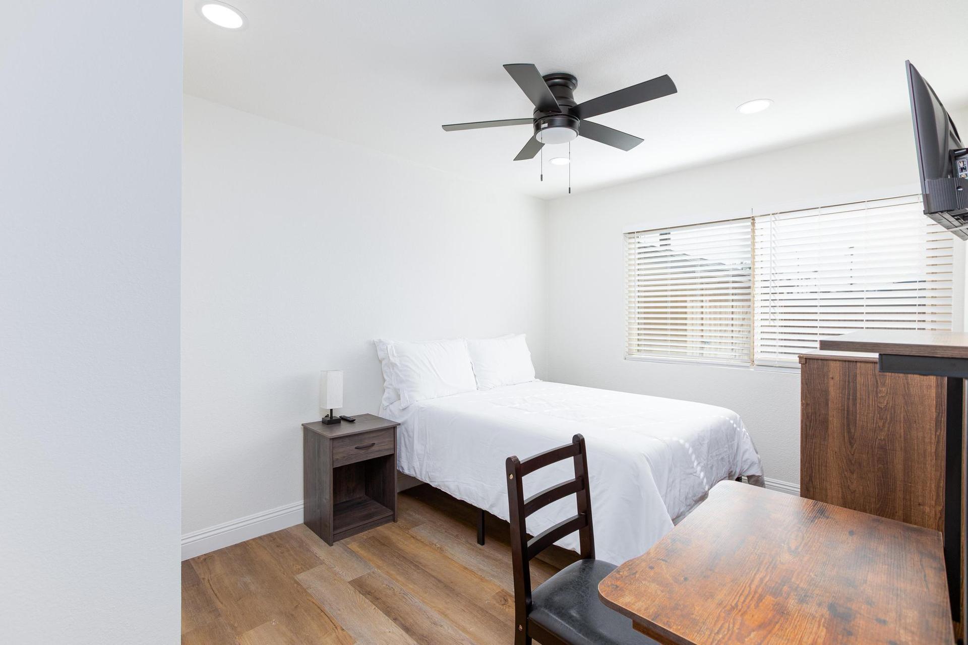 Room 4 full size bed, workstation and ceiling fan