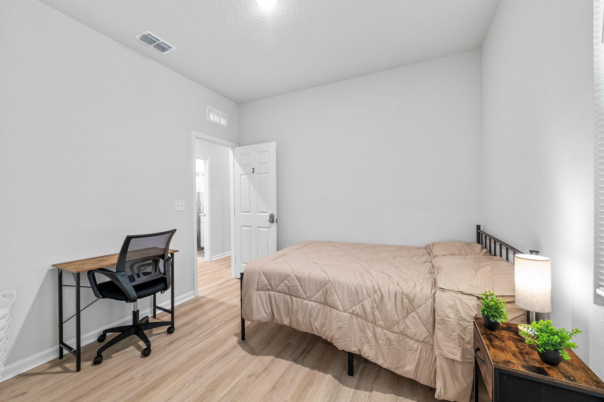 Full size bed with new linens, desk, chair, mini fridge, nighstand with lamp, spacious closet, with full length mirror.