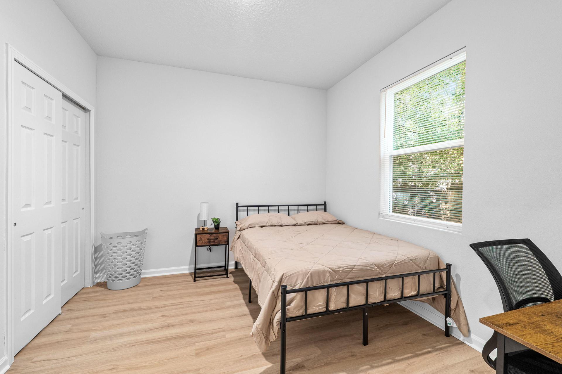 Full size bed with new linens, desk, chair, mini fridge, nighstand with lamp, spacious closet, with full length mirror.