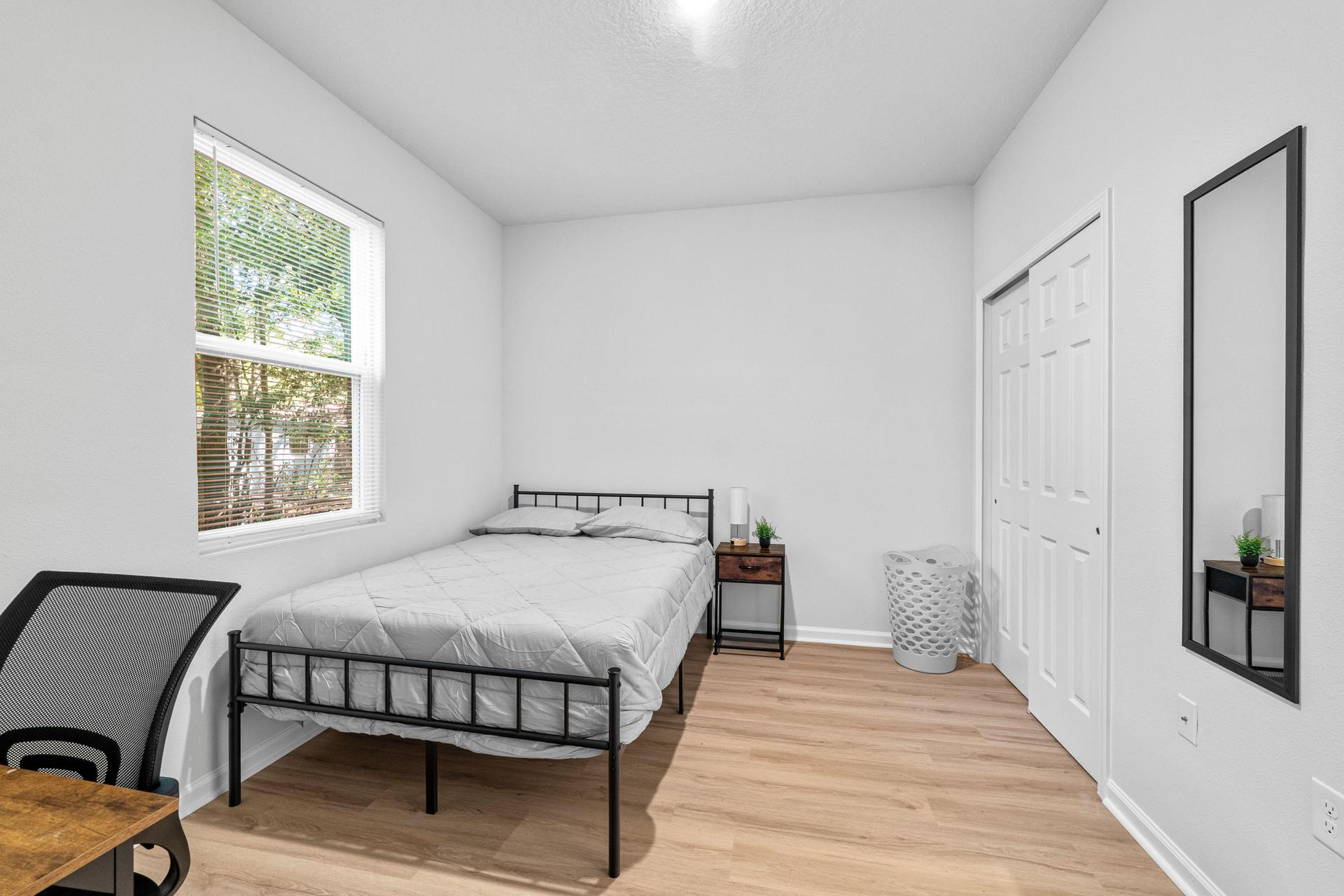 Full size bed with new linens, desk, chair, mini fridge, nighstand with lamp, spacious closet, with full length mirror.