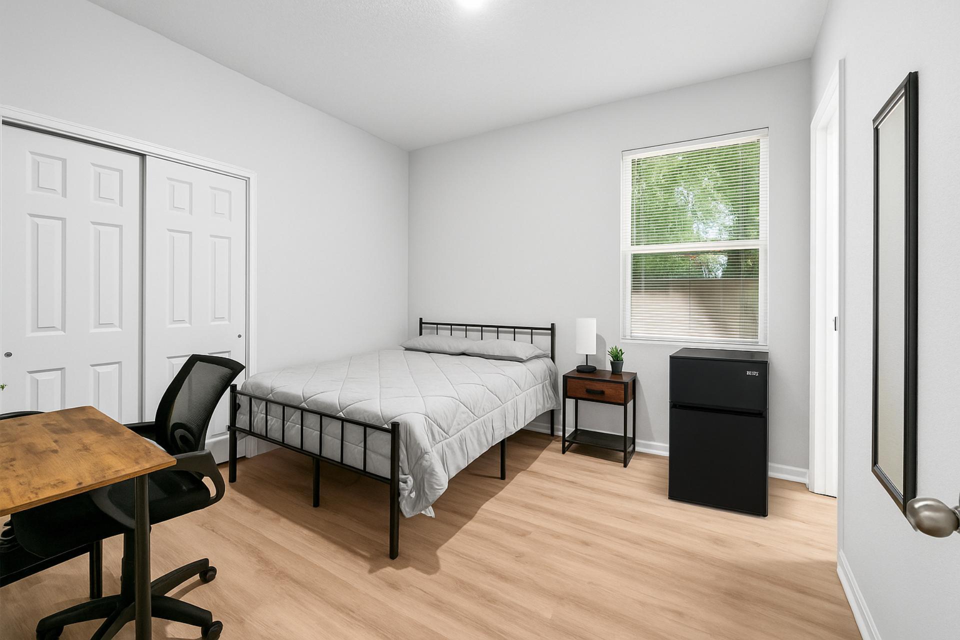 Full size bed with new linens, desk, chair, mini fridge, nighstand with lamp, spacious closet, with full length mirror.