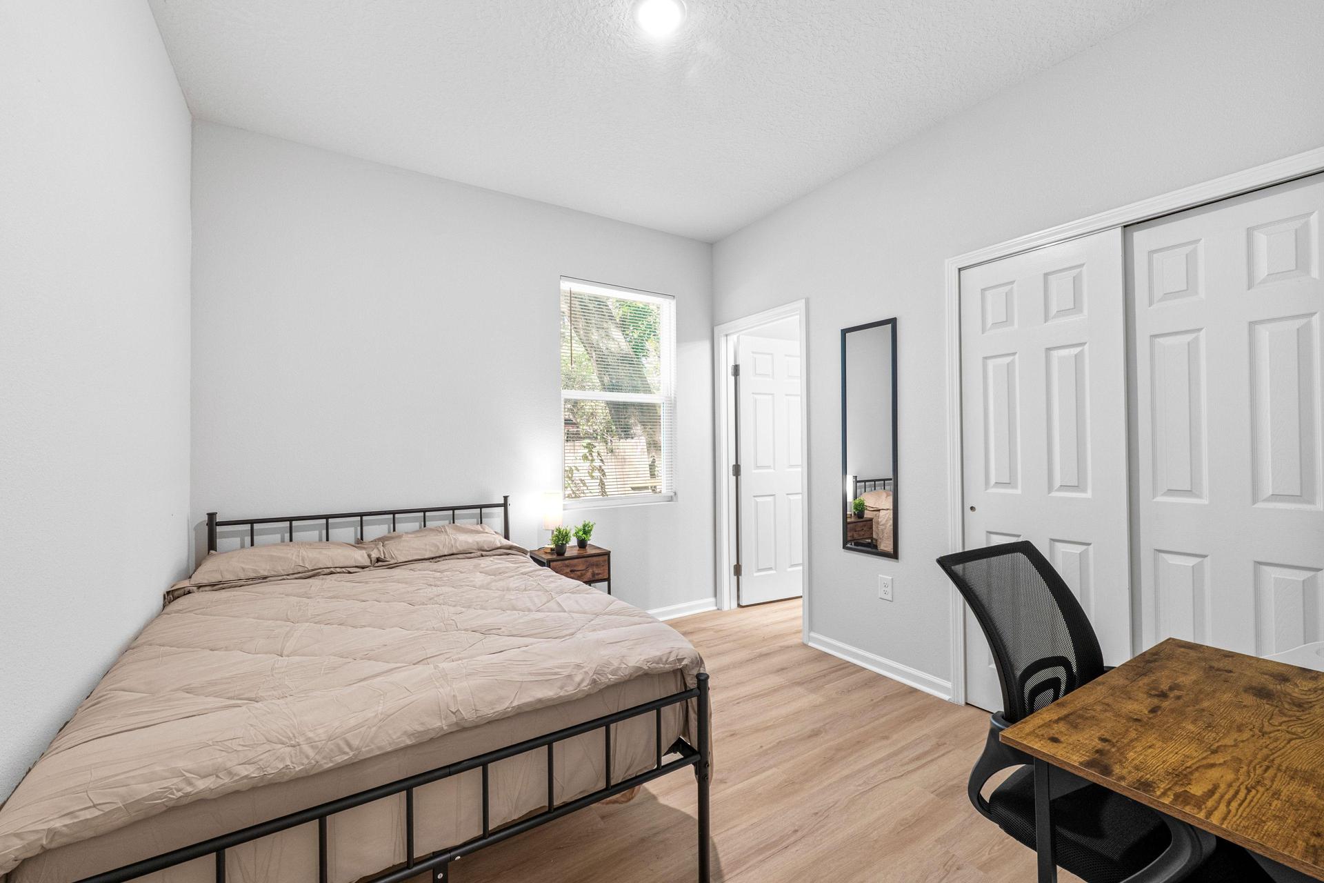 Full size bed with new linens, desk, chair, mini fridge, nighstand with lamp, spacious closet, with full length mirror.