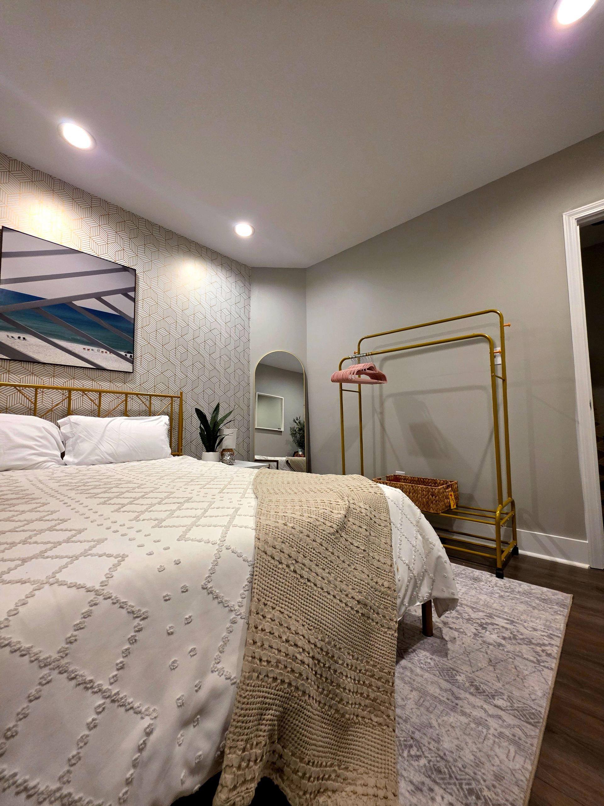 Open room with storage, seating, TV and full-length mirror