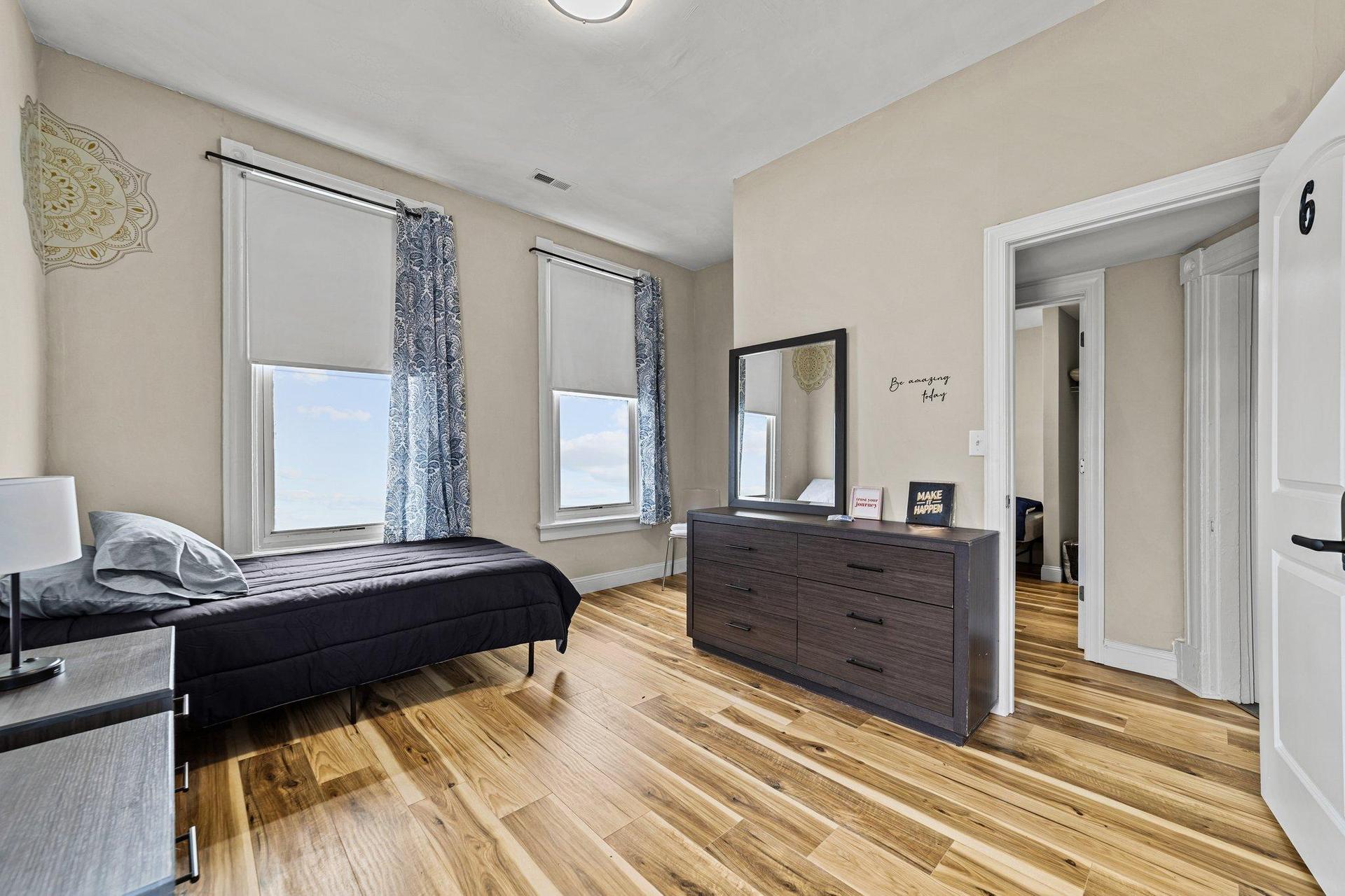 Pretend that this room was laid out properly with the bed between the nightstands. This large room has a closet tucked away .