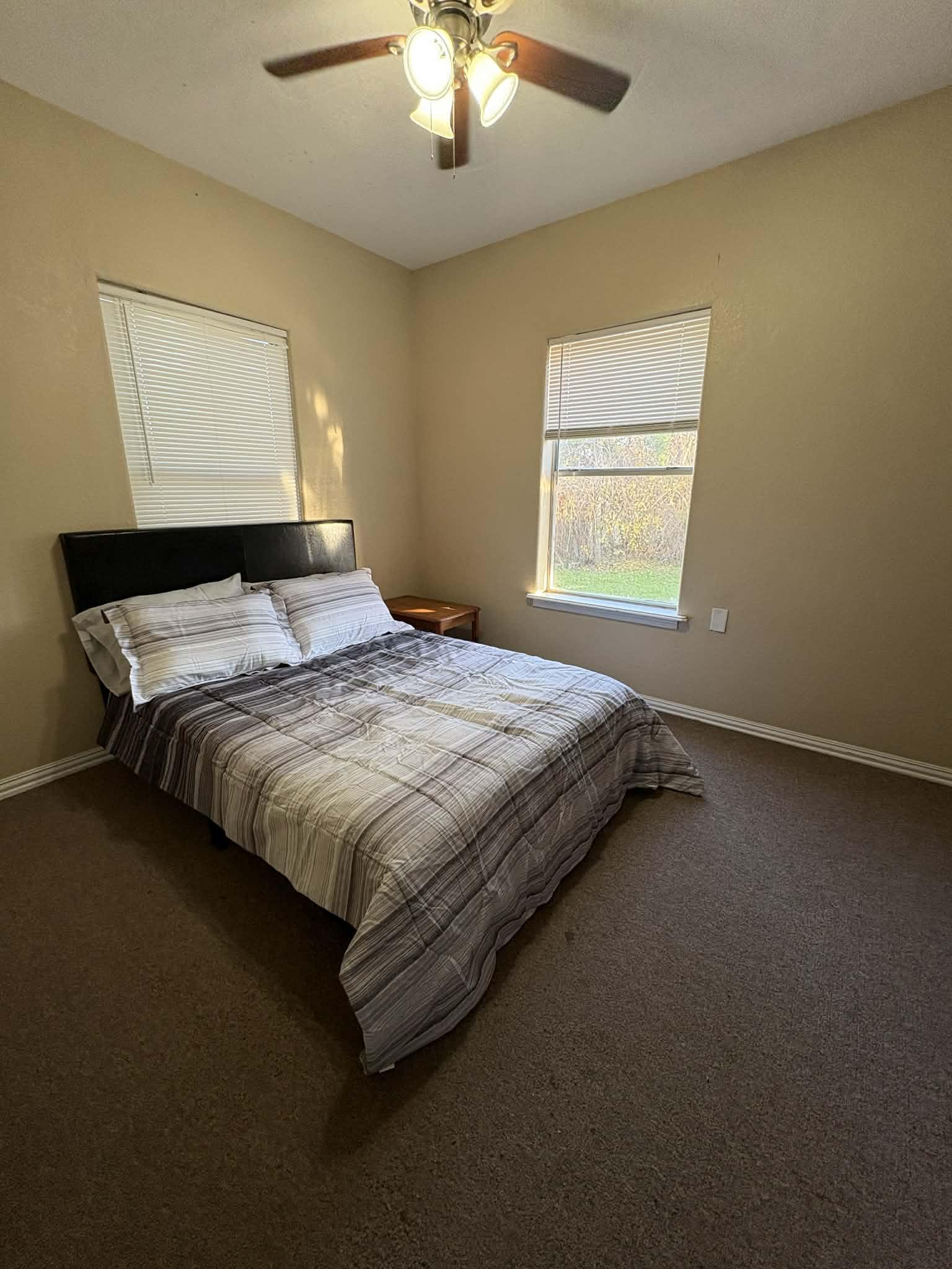 Full size bed with black and gray linens
