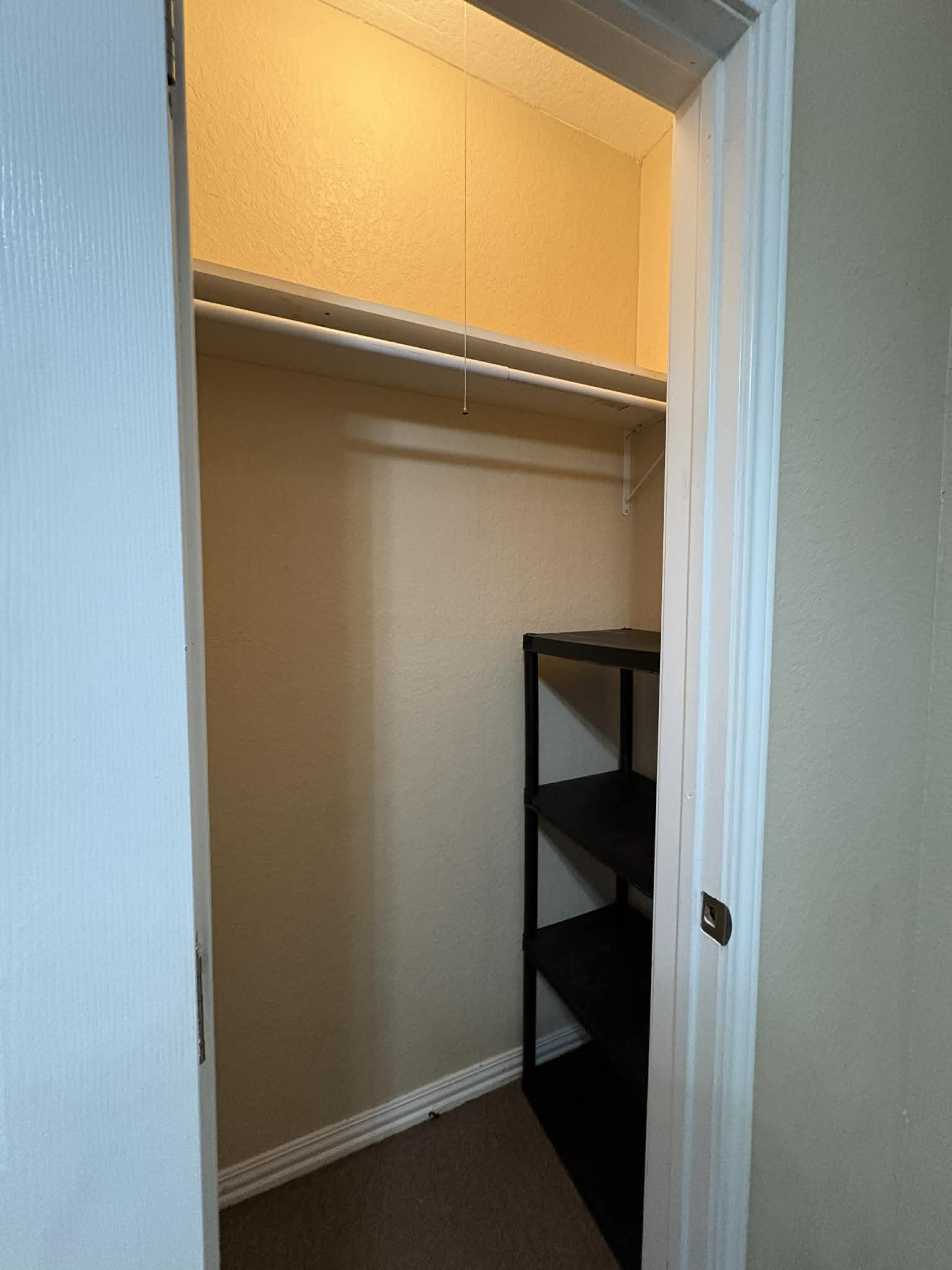 Large reach-in closet with shelves for additional storage