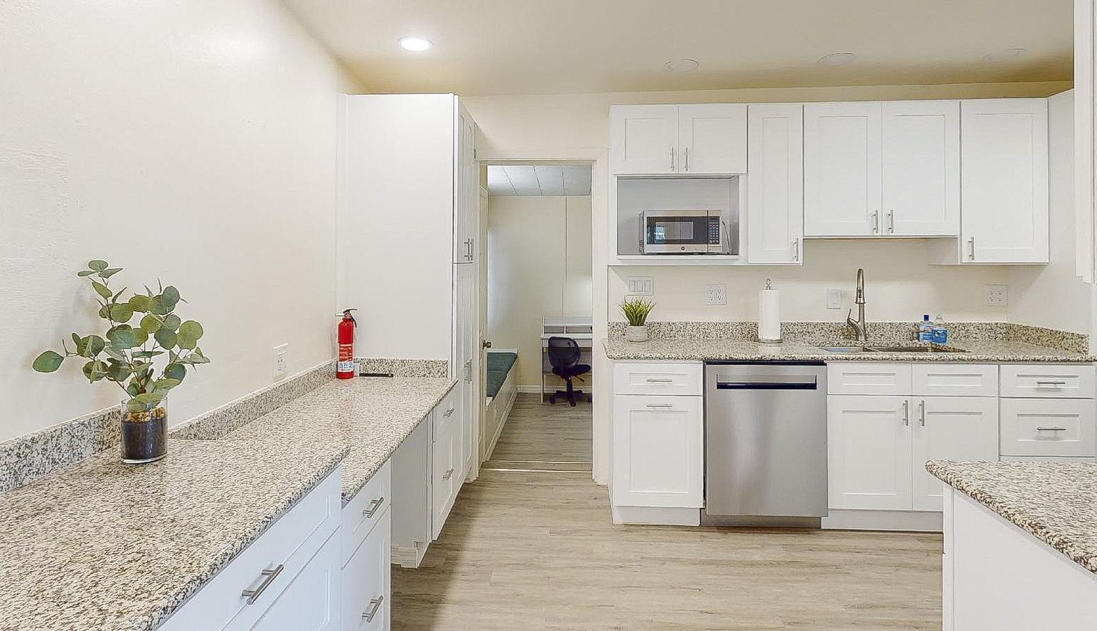 From the entry and dining area into the kitchen with the work area for recipes or computer work on the left