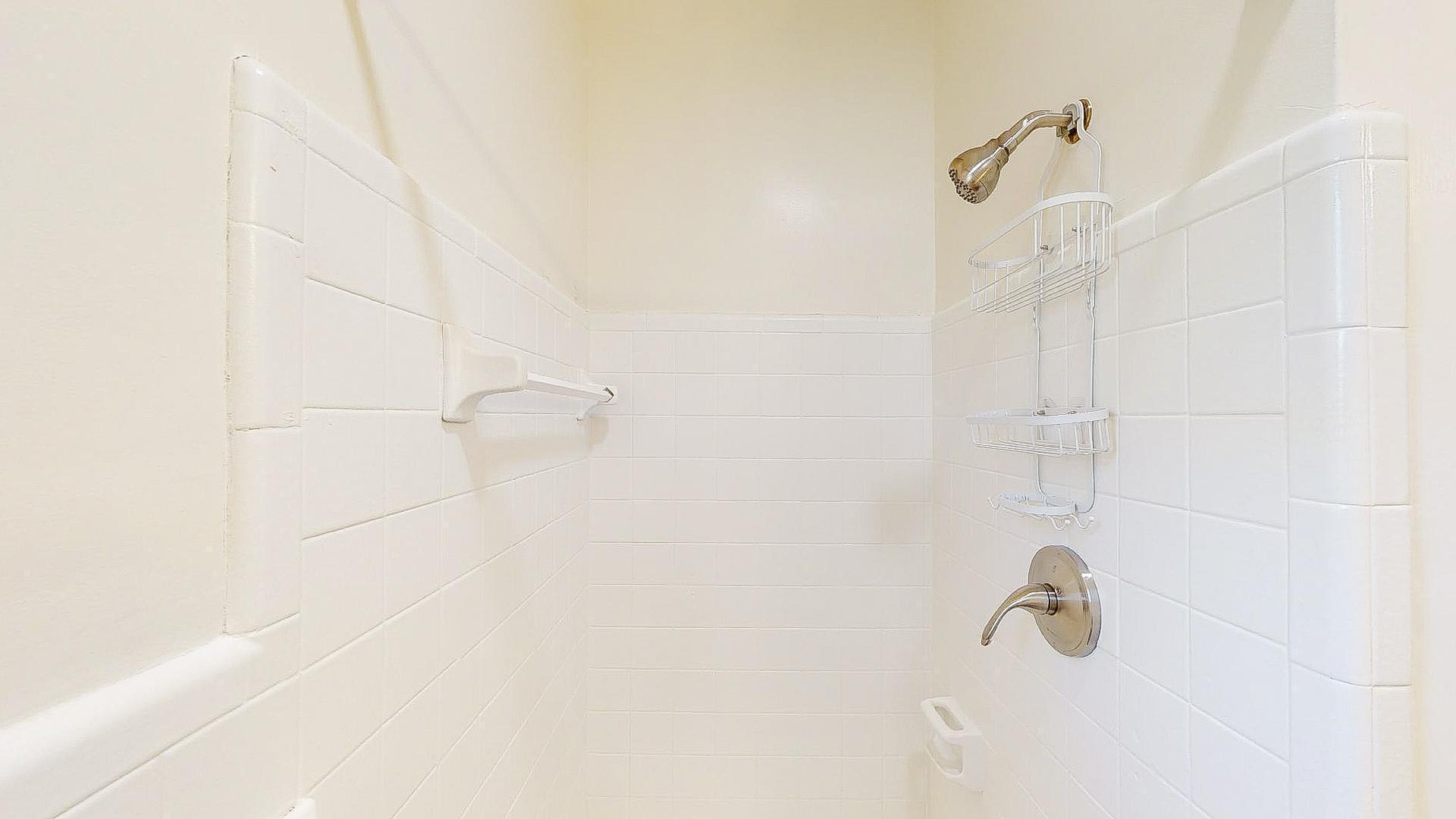 Shower in bathroom with double sink