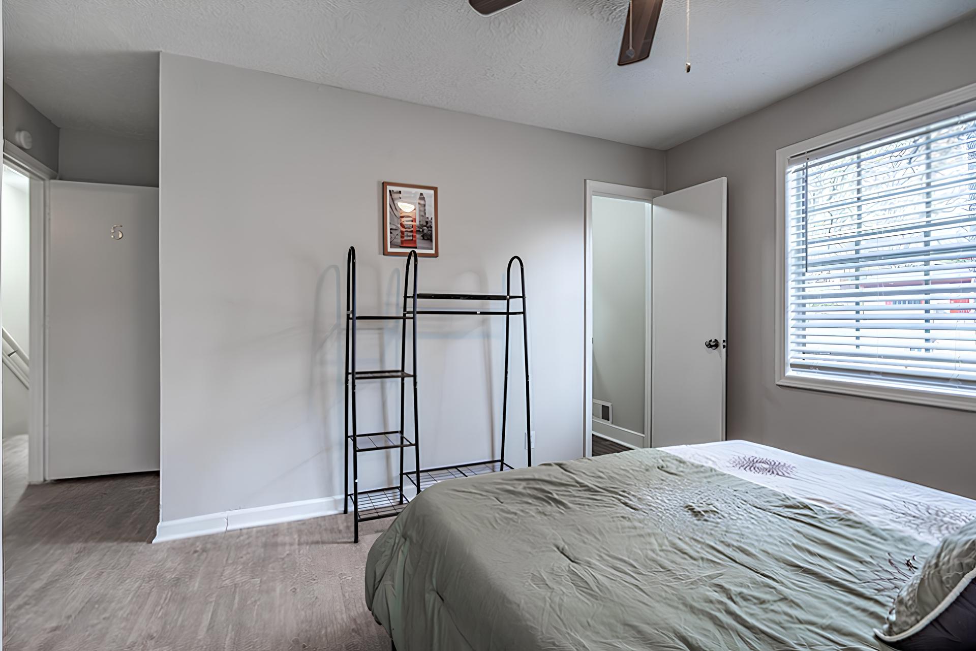 bedroom, detected:window blind, bed, ceiling fan