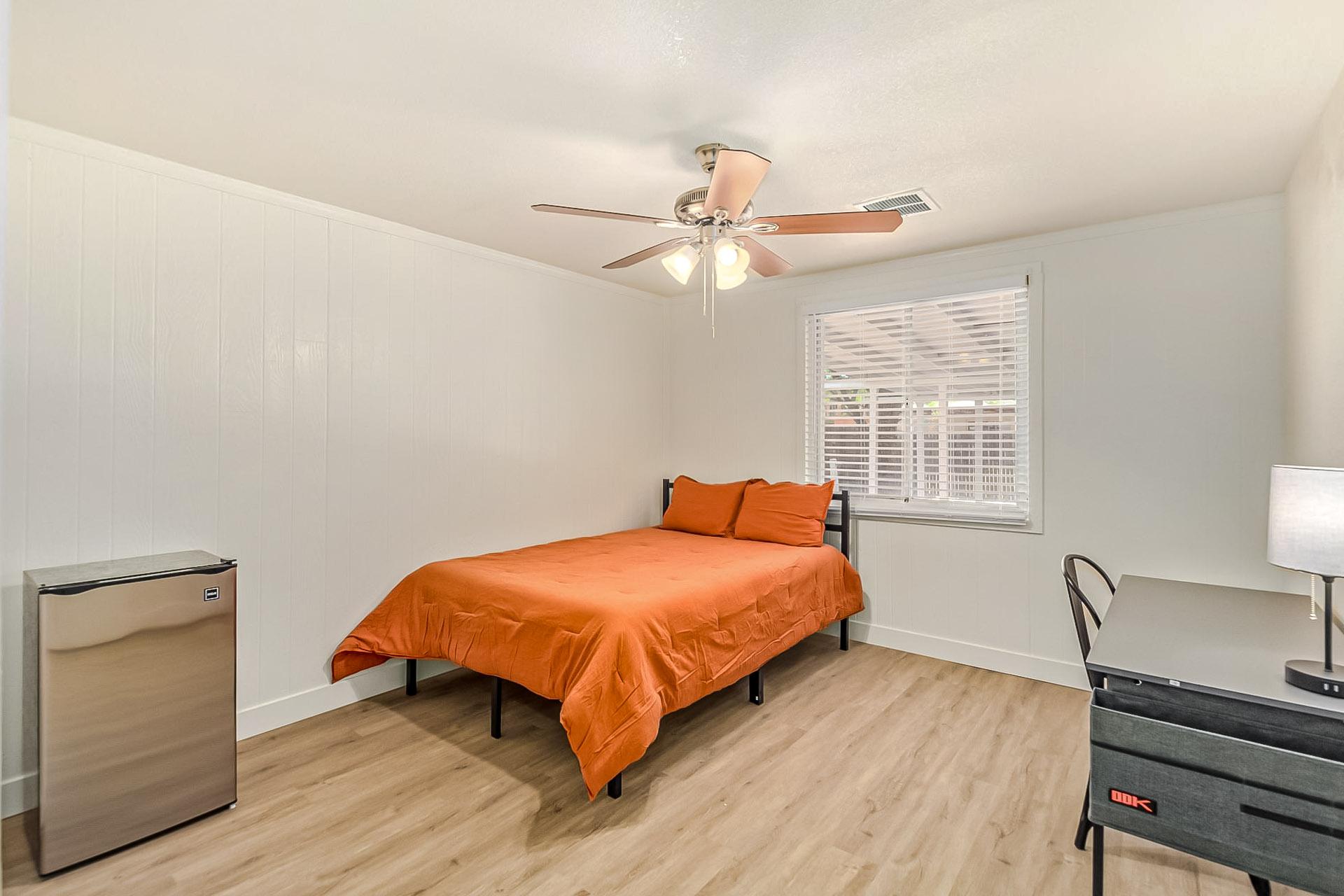 Full size bed, desk, chair, and mini fridge.