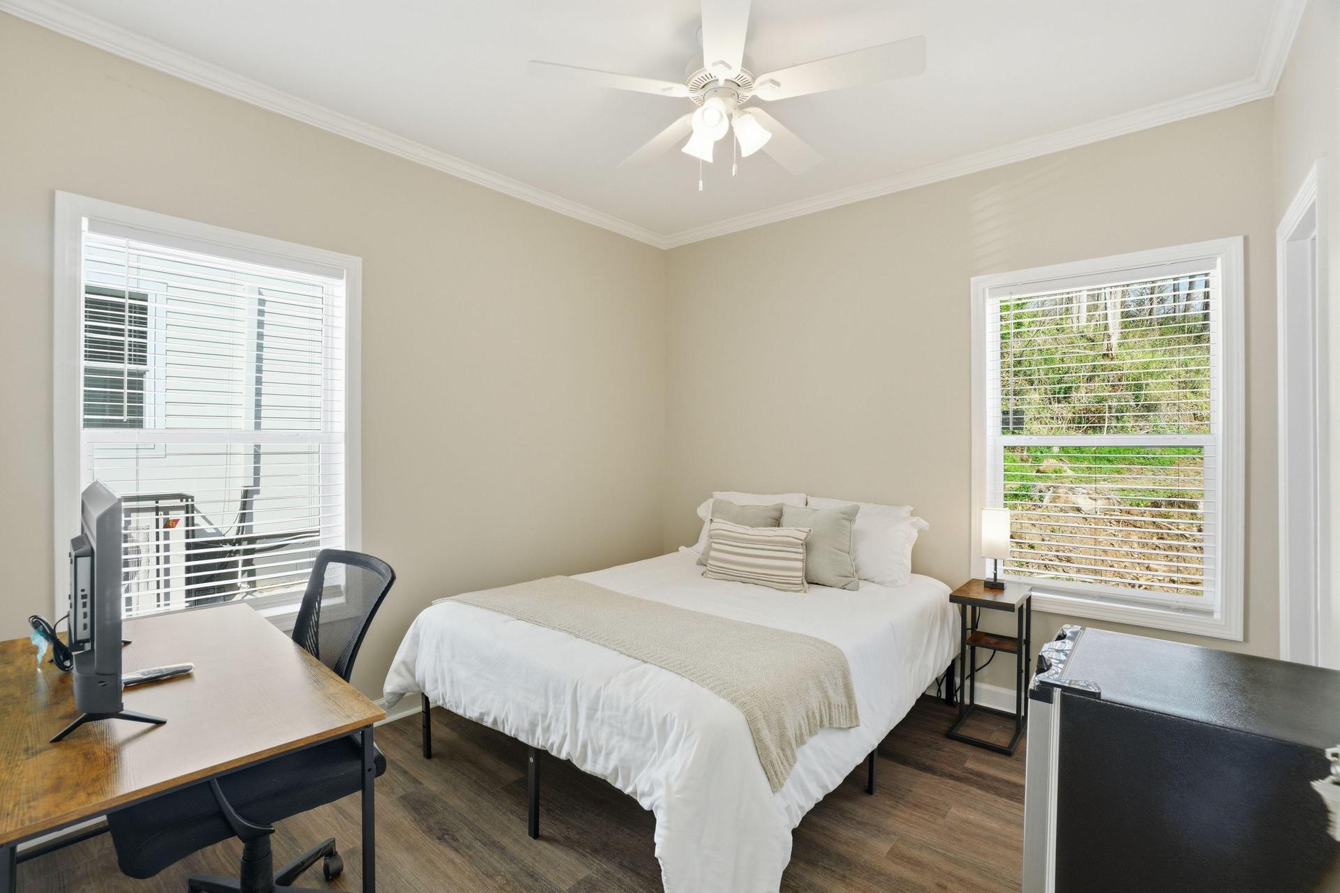 Queen bed, workstation with Roku TV, and mini fridge included! Mattress cover included. Bed linens not included