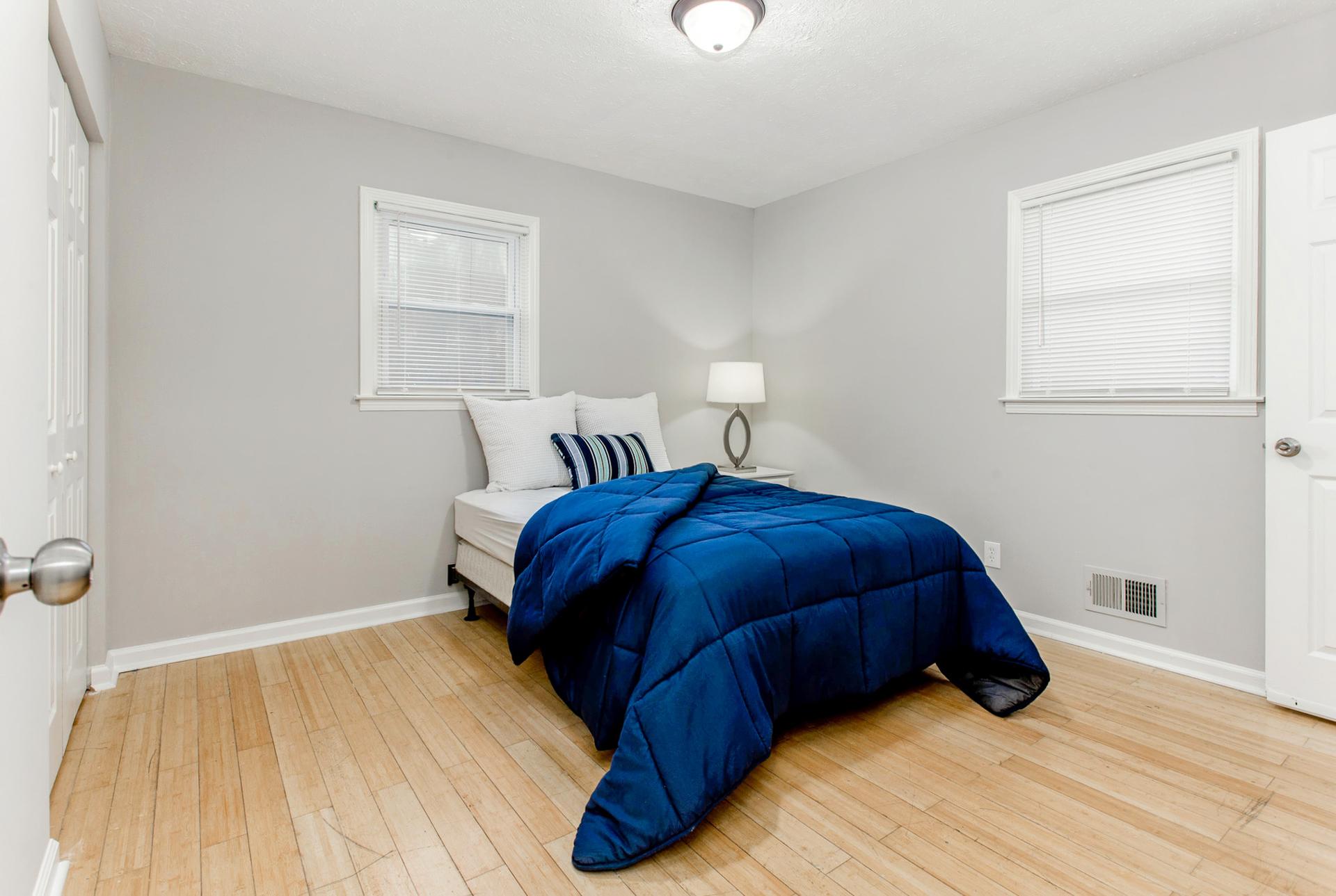 Room 1.  Double bed, closet, nightstand and lamp.