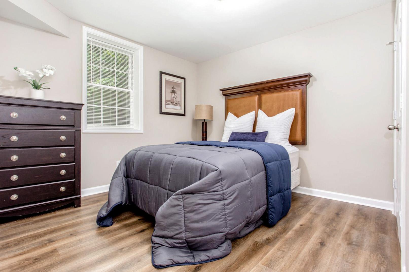 Downstairs bedroom with large closet,  dresser, nightstand.