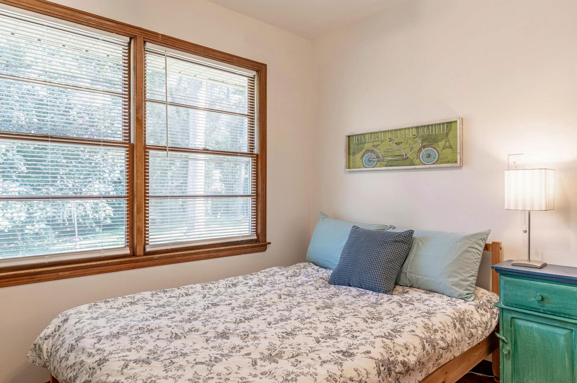 Room 1 has a full-size bed and great light. Windows look into back yard.