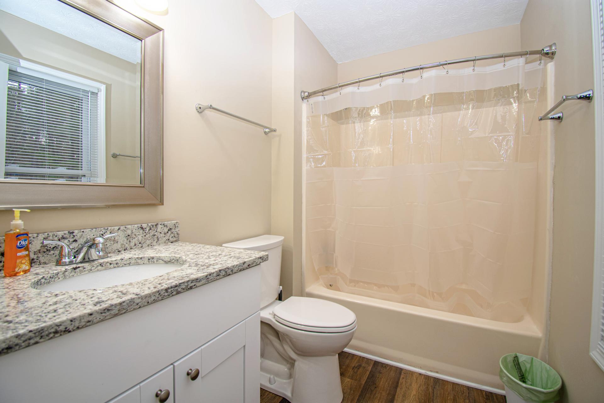 Main bedroom private full bath with granite counter top.