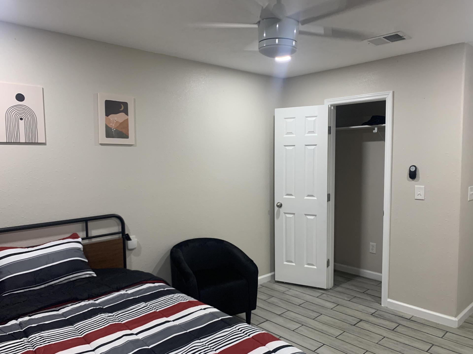 Spacious room, Ceiling fan, seating.