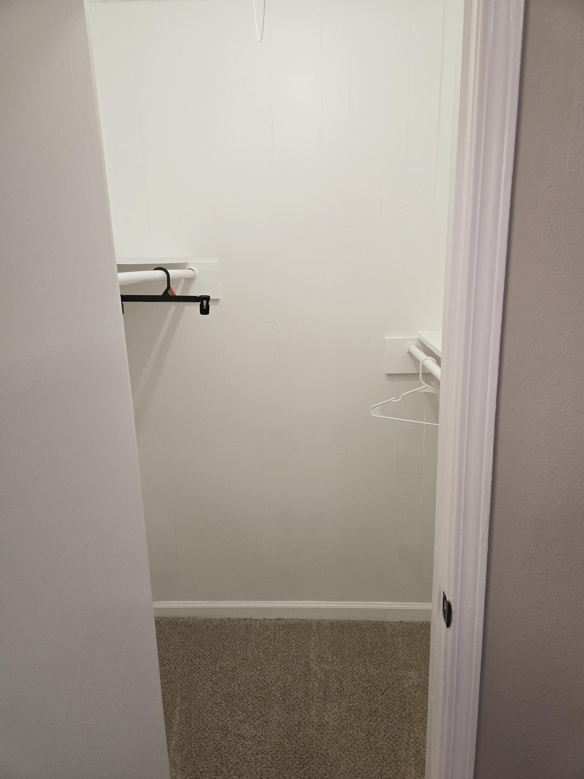 Walk In closet with shelves and clothing rods