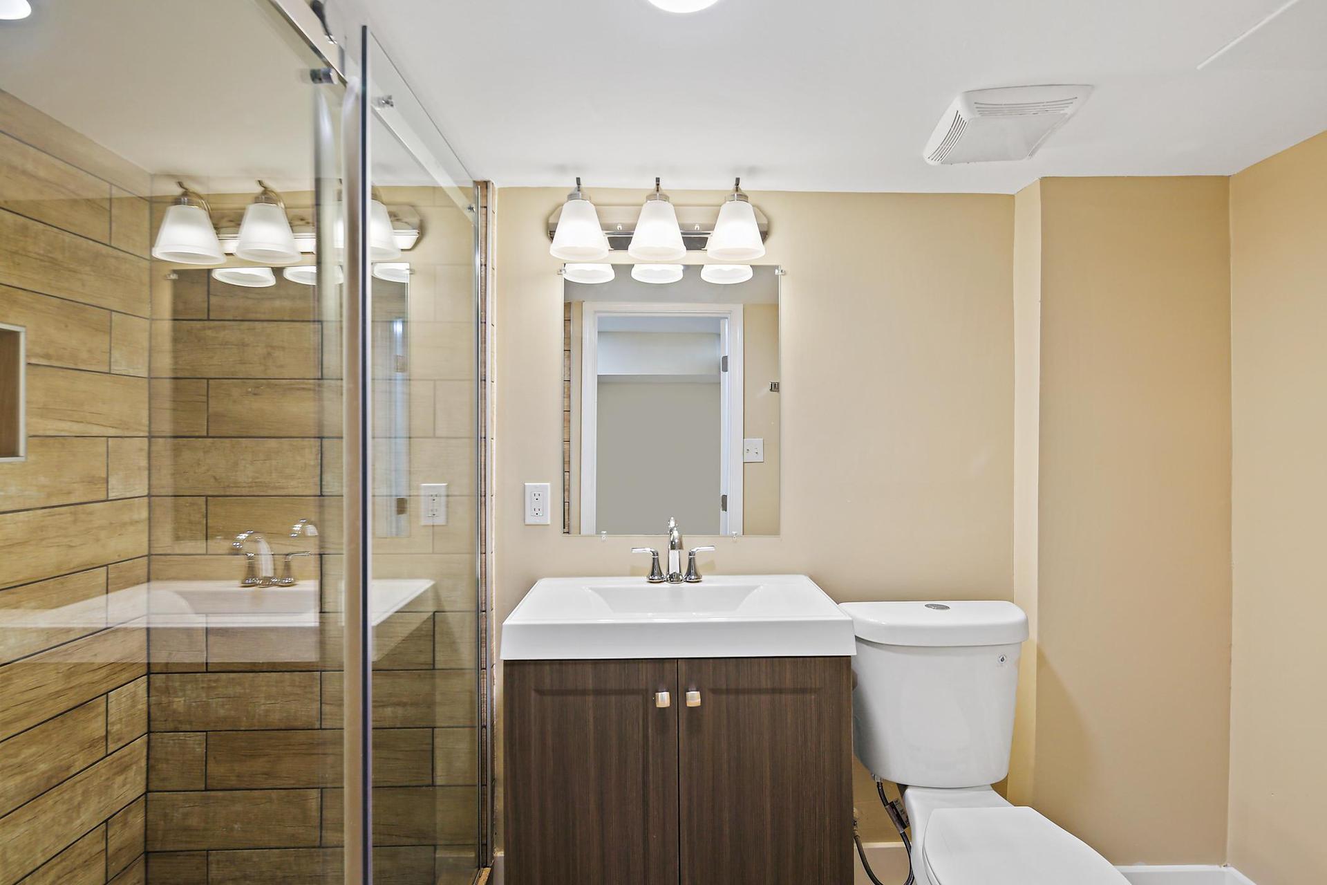 Brand new private bath with glass shower doors