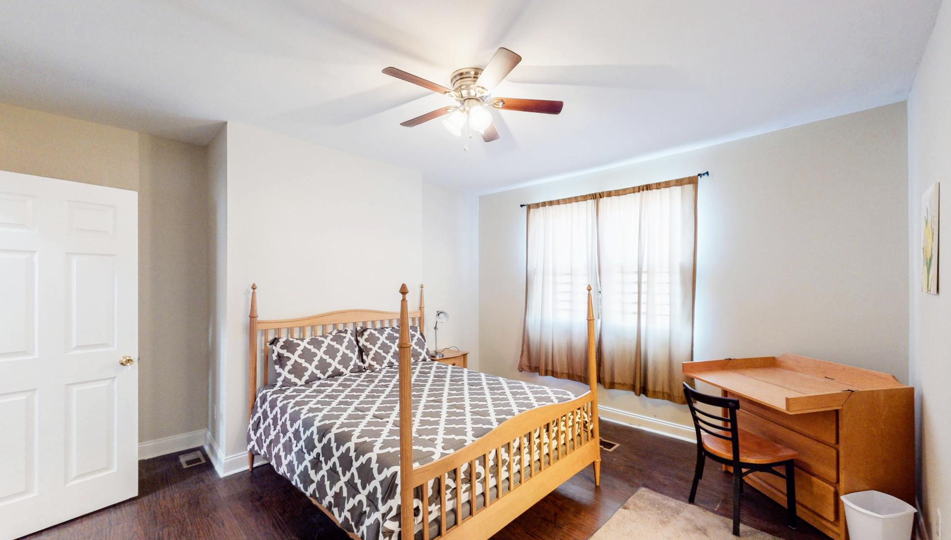 Bedroom 1 with Queen 4 poster and desk.