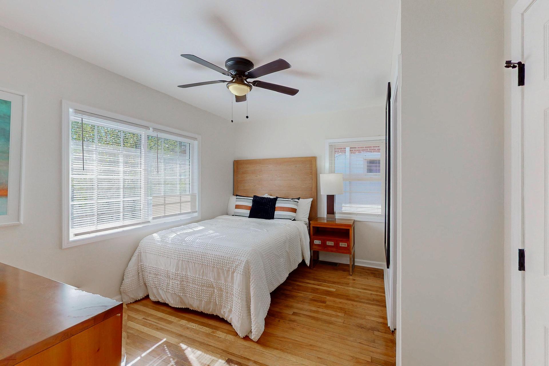 Light-filled room with a queen bed.  This room is about 13.5 ft by 10.5 ft.