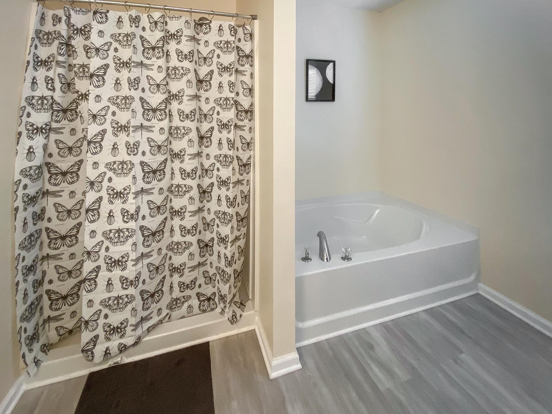 bathroom, detected: hardwood, bathtub, window blind, shower