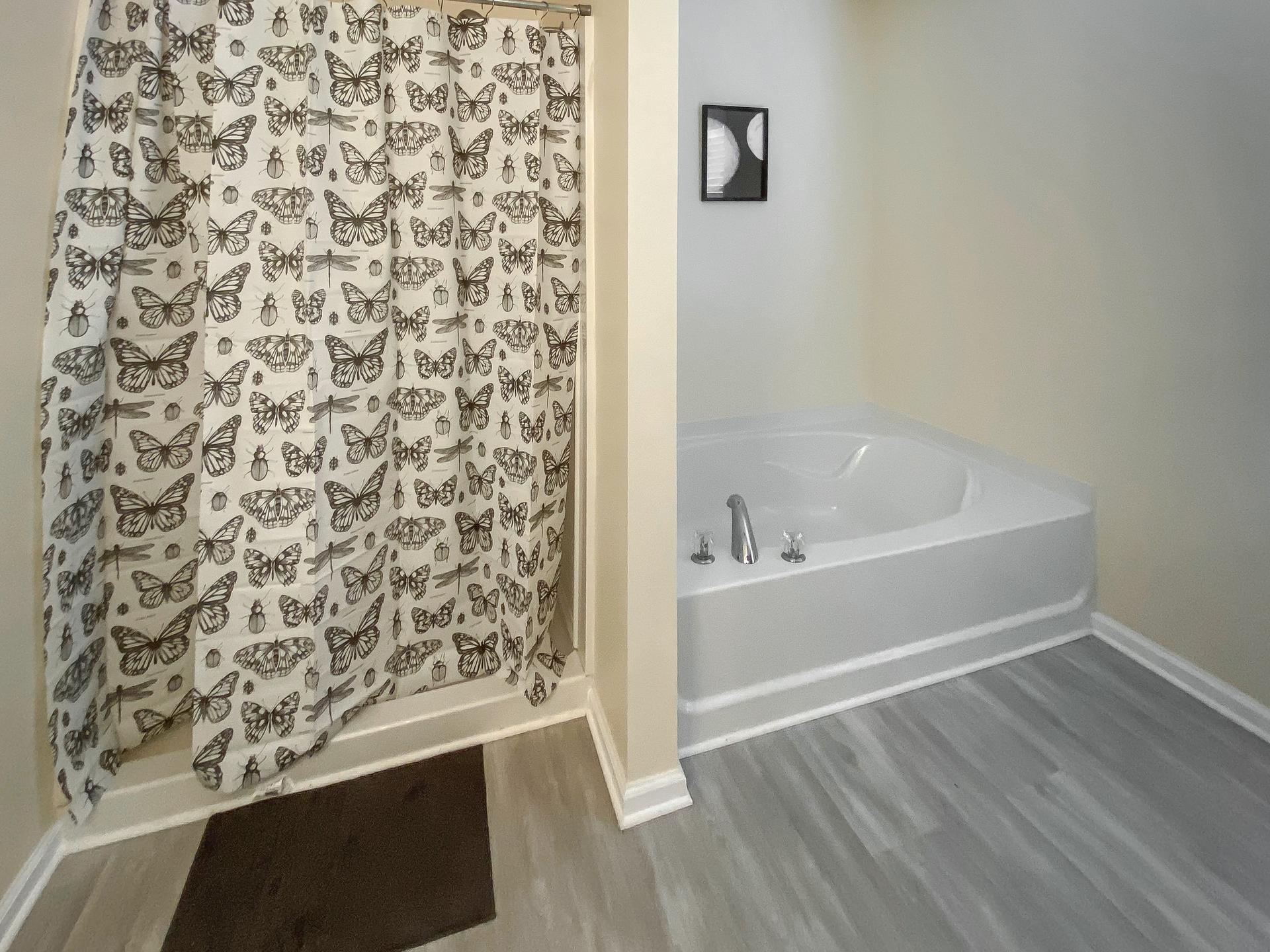 bathroom, detected: hardwood, bathtub, window blind, shower