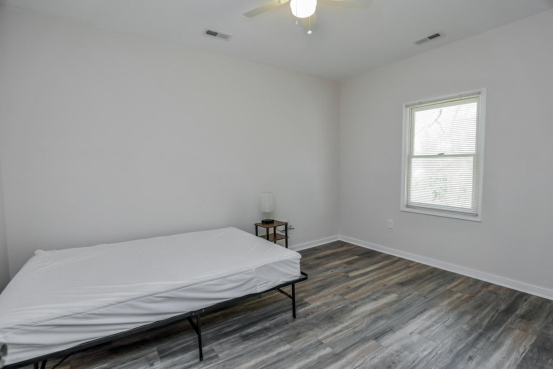 bedroom, detected: hardwood, window blind, bed