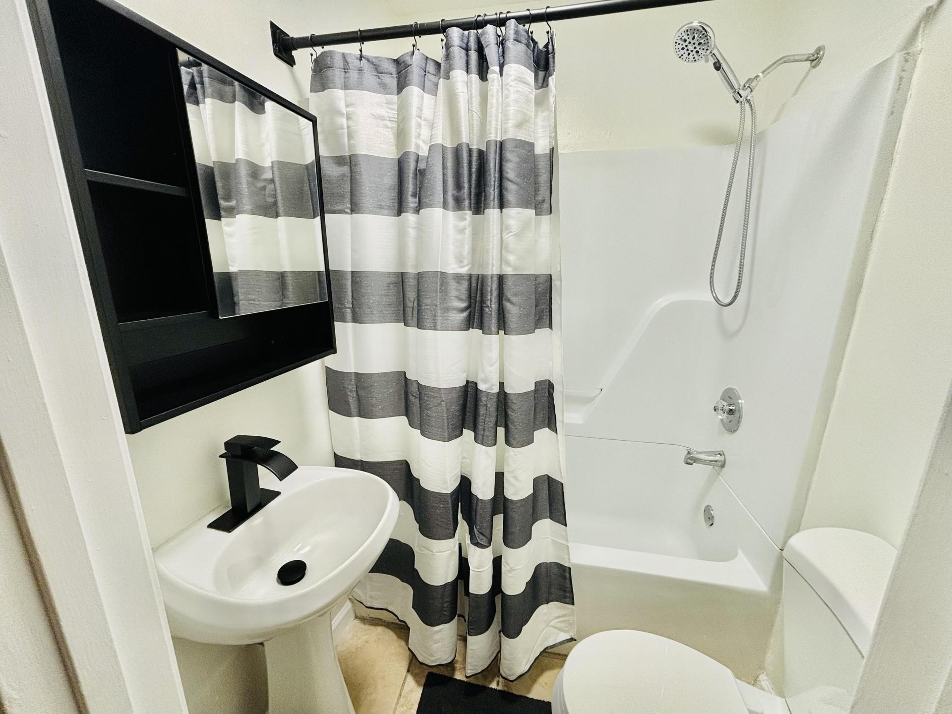 Shared hallway bathroom with tub and shower combo