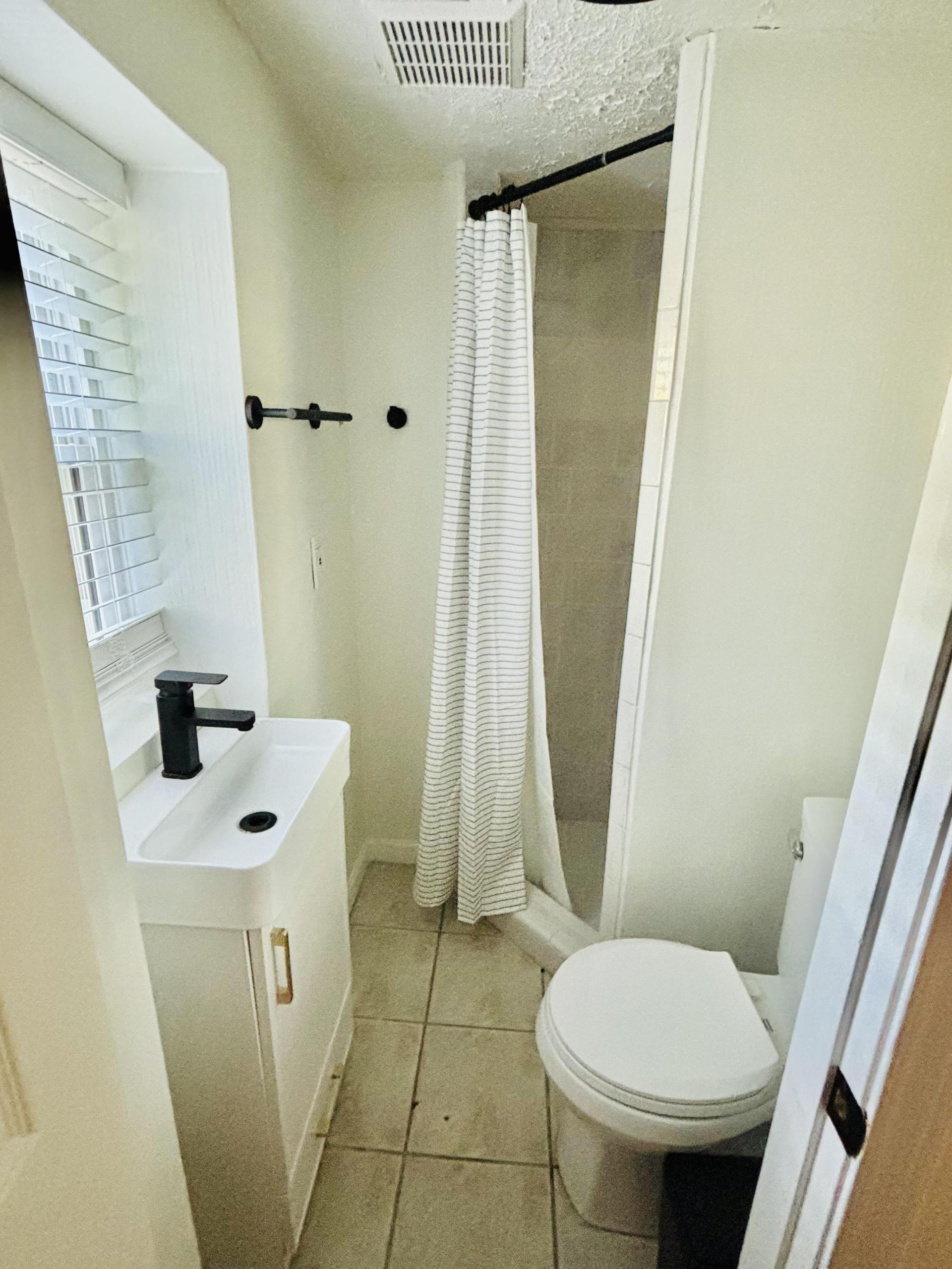 Shared hallway bathroom with stand up shower