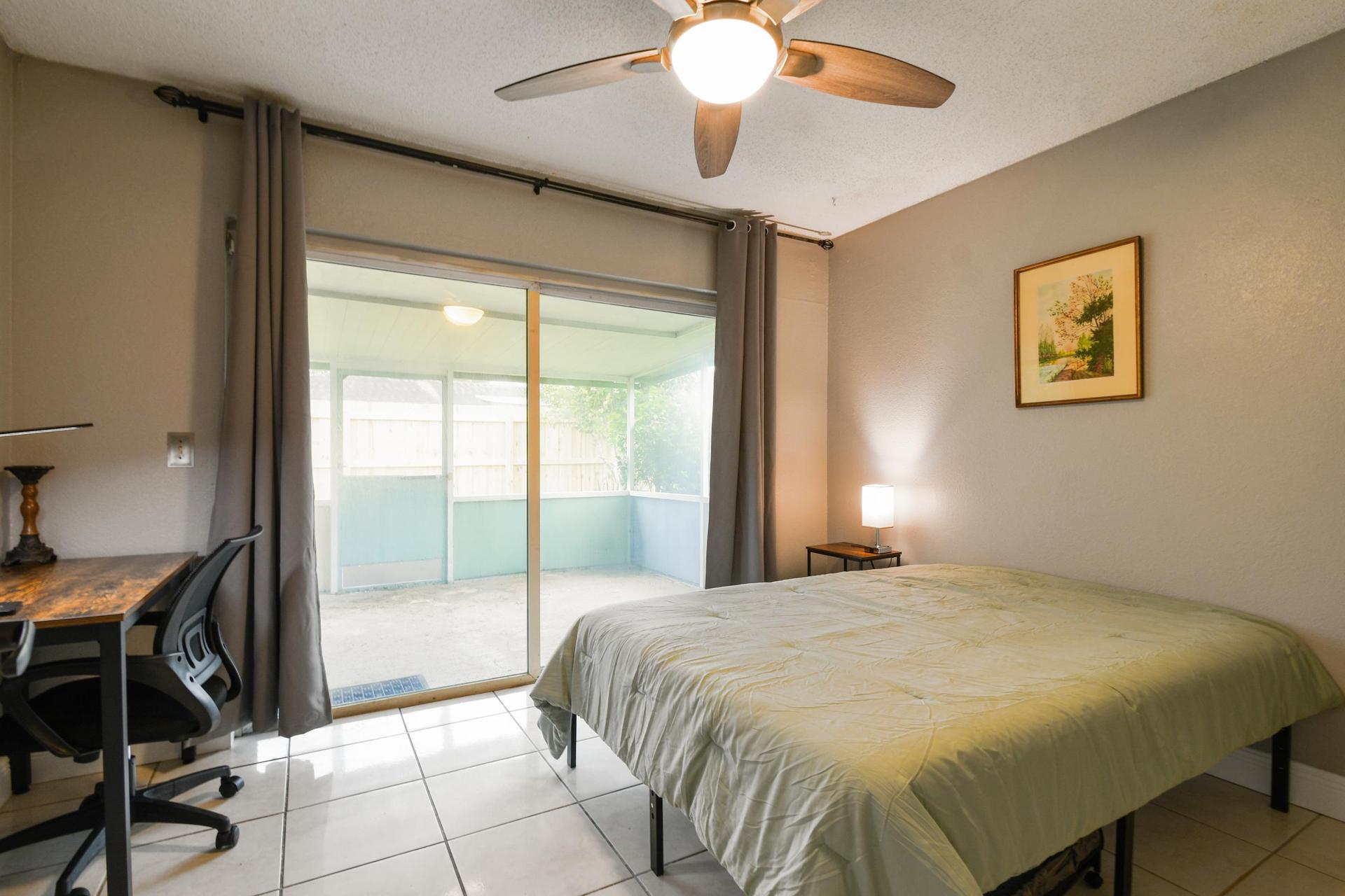 Full size cozy bed, with end table, light and storage container under the bed.  Black out curtains for your own sliders