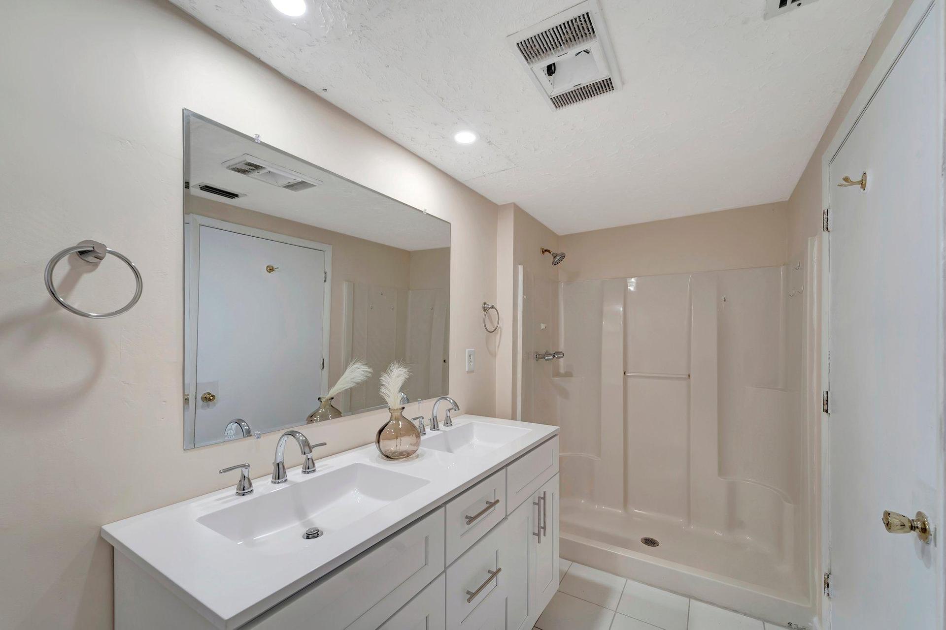 Bathroom A has a large double vanity and plate glass mirror.  Shower Only (not pictured - shower curtain and rod)