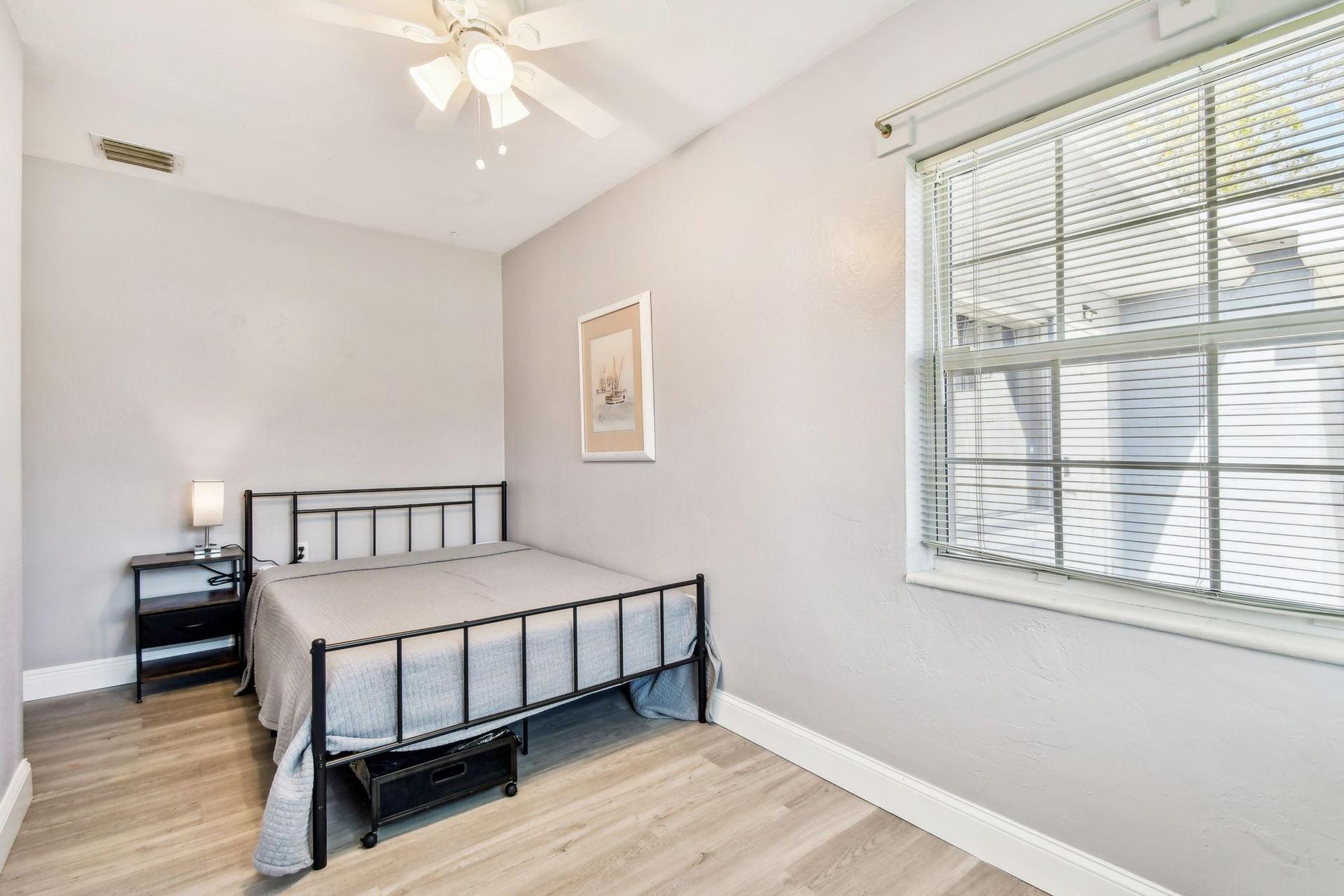 Full size cozy full size bed, with end table, light, desk, office chair and light, storage container under the bed and closet