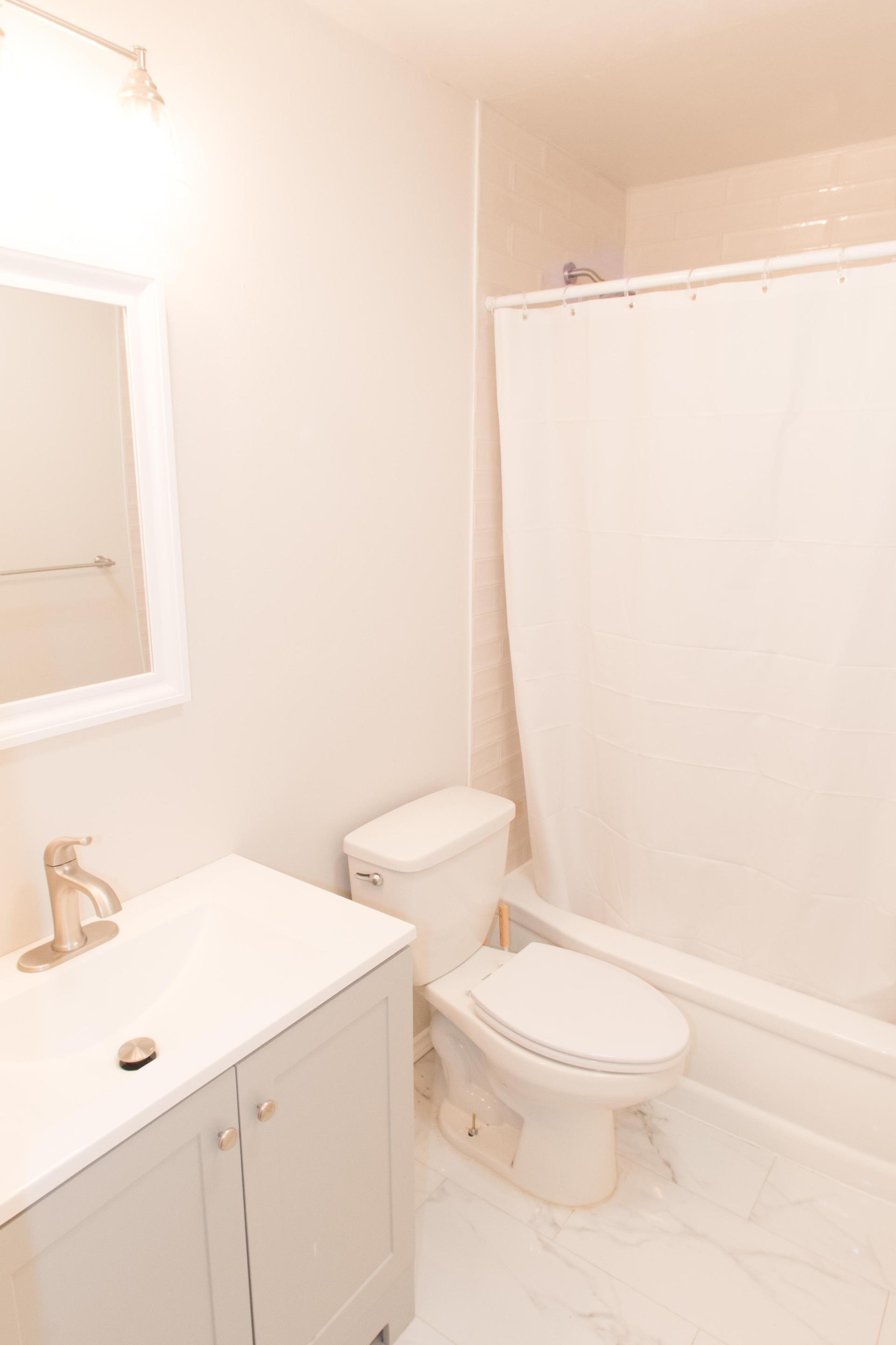 Shared bathroom with tub.
