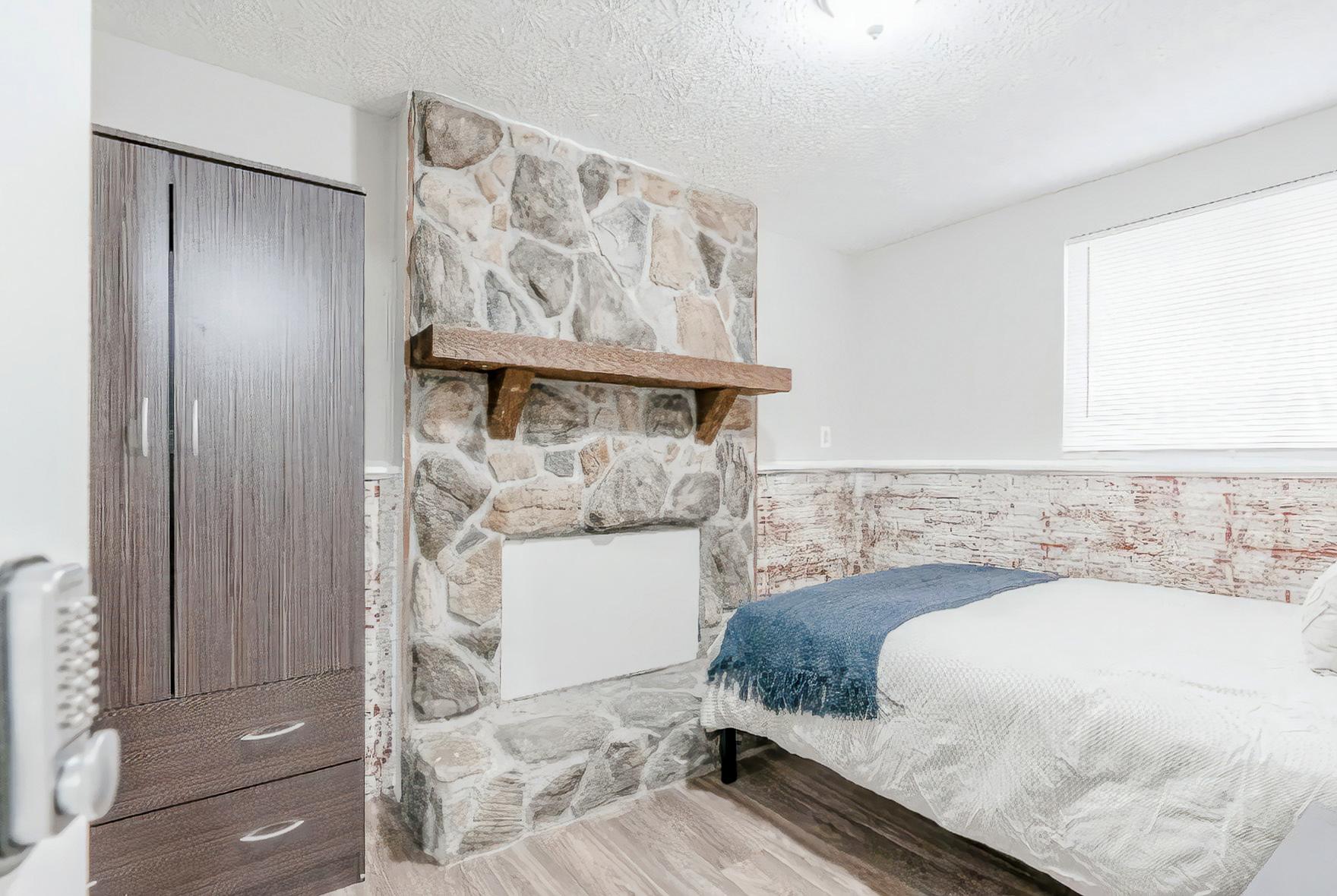 Gorgeous room with brick accents and faux fireplace