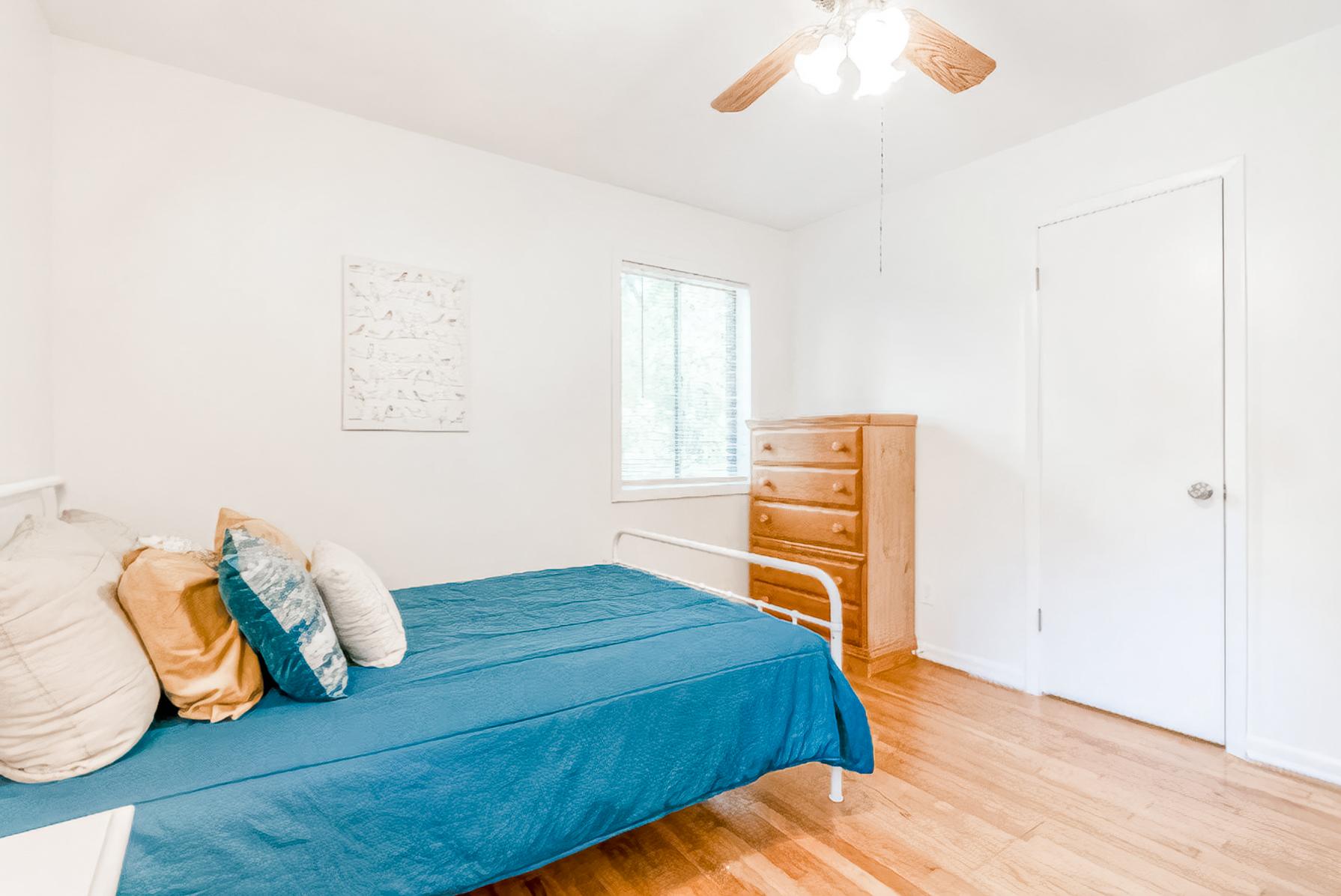 This corner room has two windows, a dresser and a built-in closet.