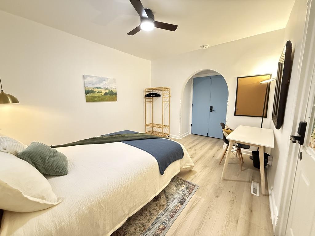 Huge room with ample lighting and a large table and desk chair