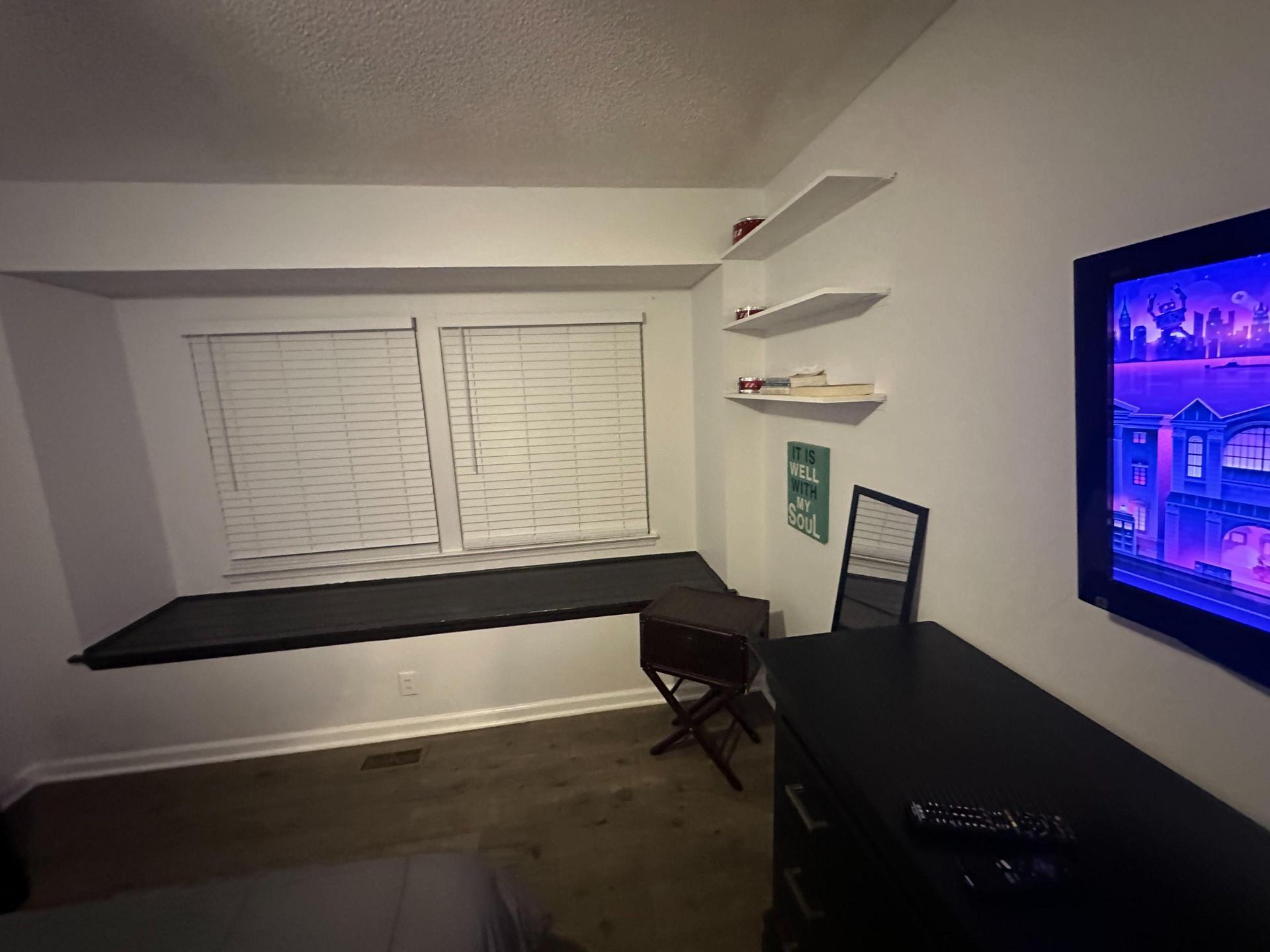 Window seat for reading and relaxing, floating shelf, full length mirror and bedroom closet.