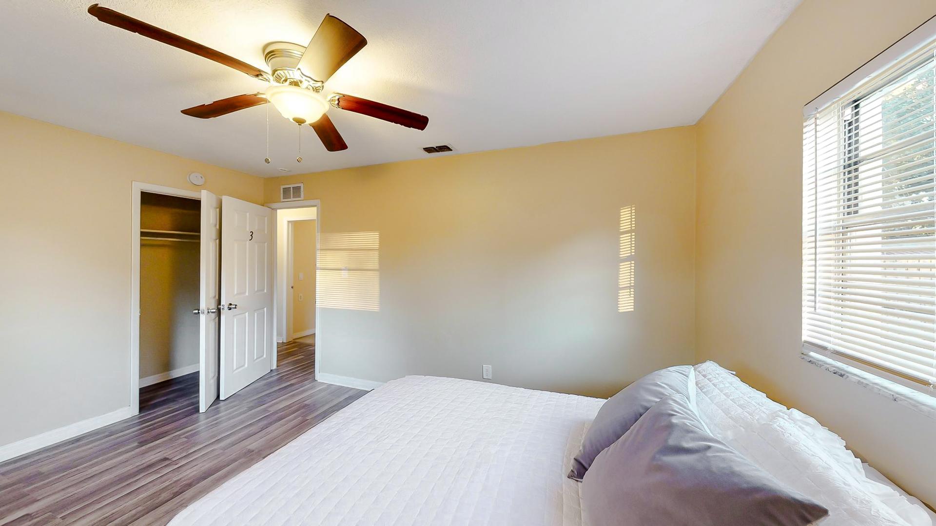 bedroom, detected: window blind, ceiling fan, bed