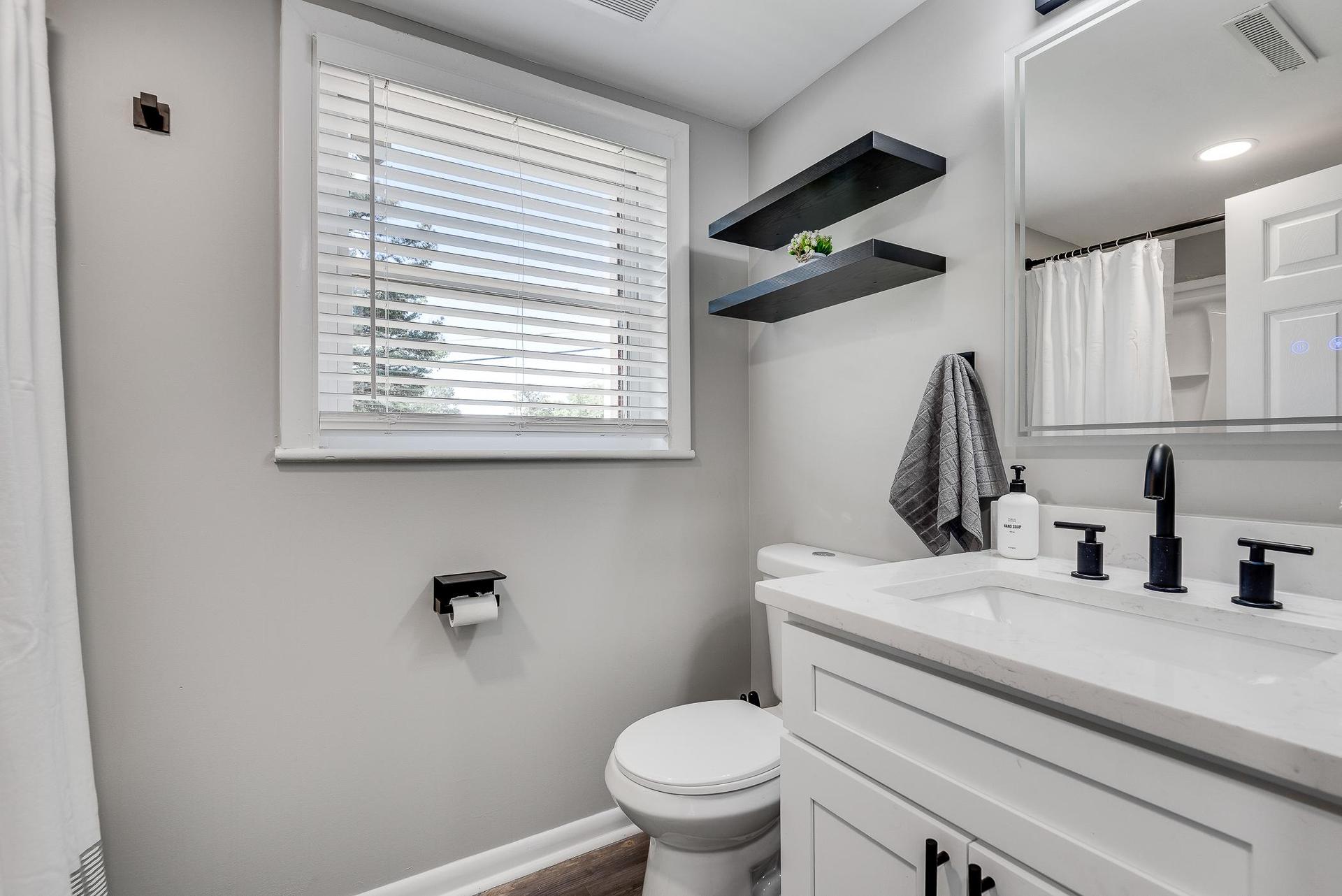 Updated Modern Bathroom located in the basement for Room 5 & 6