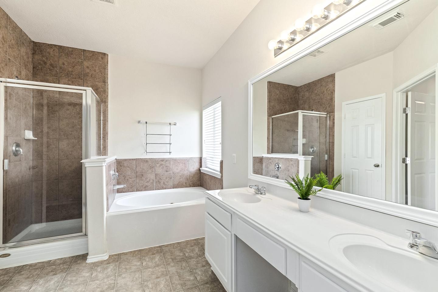 Double vanity anyone? This luxurious bathroom has standup shower and separate large tub!