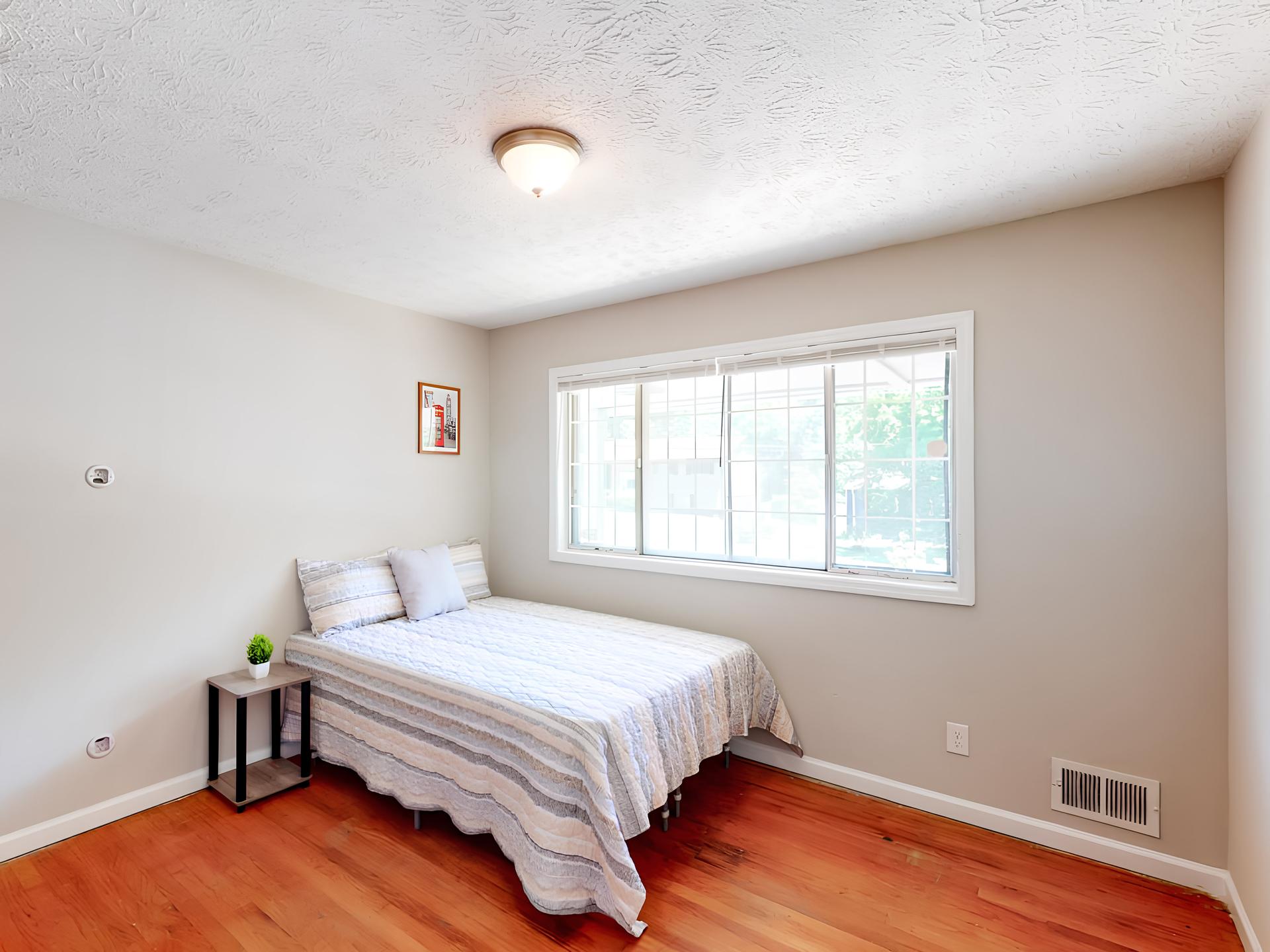 on the top floor, full-bed, with wide street view window. Across from the kitchen. Room size of 11'6"x10'5"