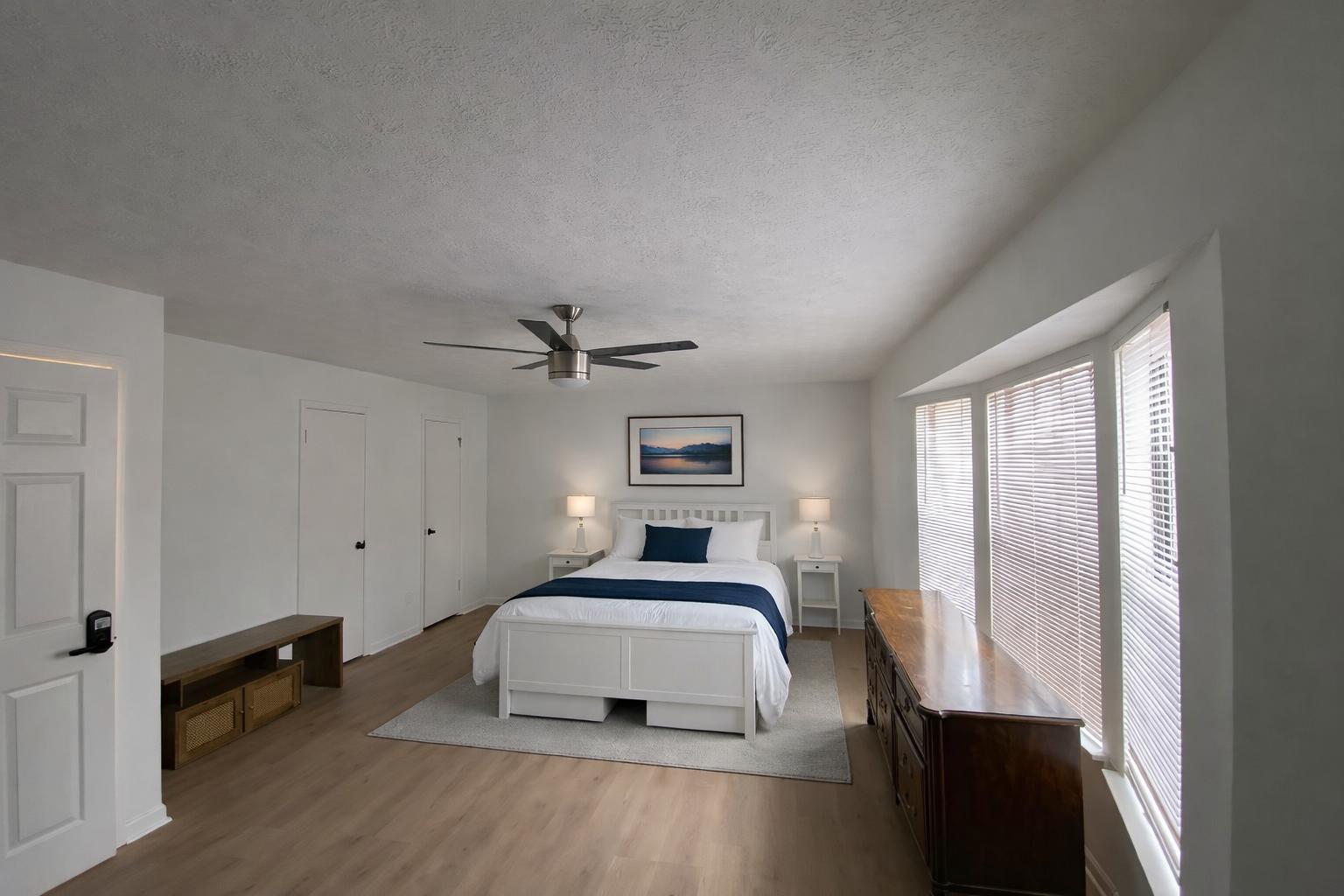 A spacious room featuring a bathroom and a comfortable couch.