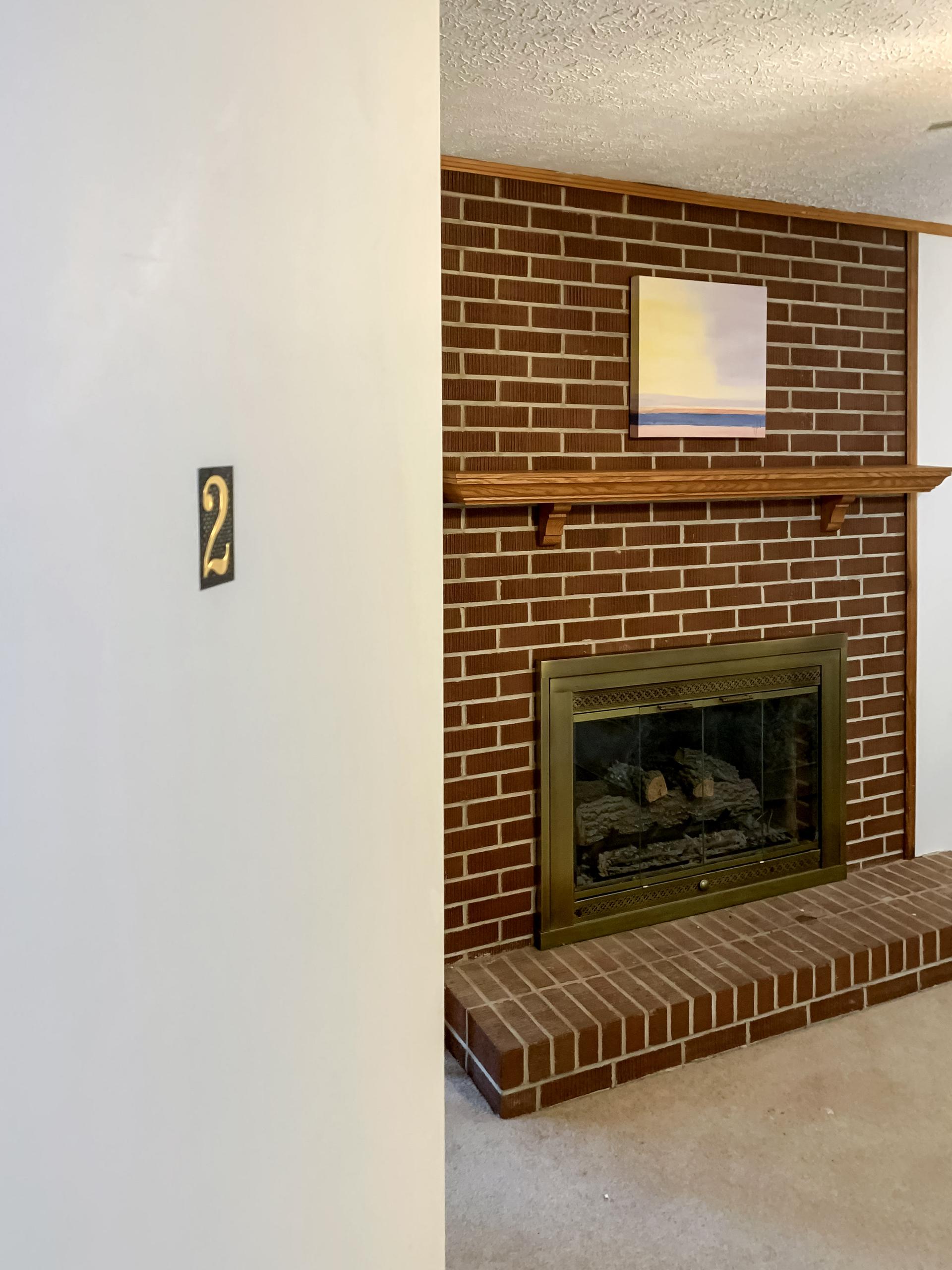 Room 2 has a decorative fireplace