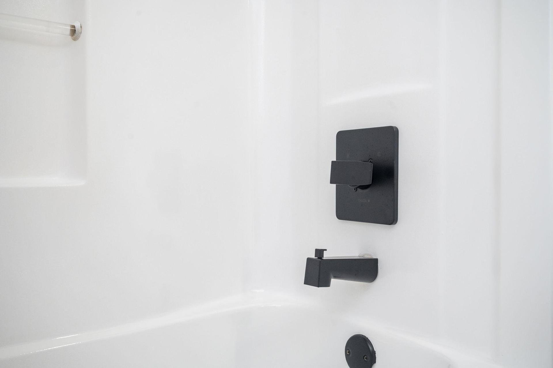 Main floor bathroom with bathtub and shower