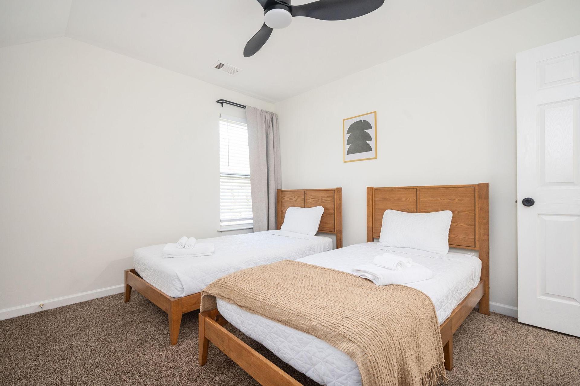 Private bedroom with two full-sized beds, ceiling light, fan, and closet