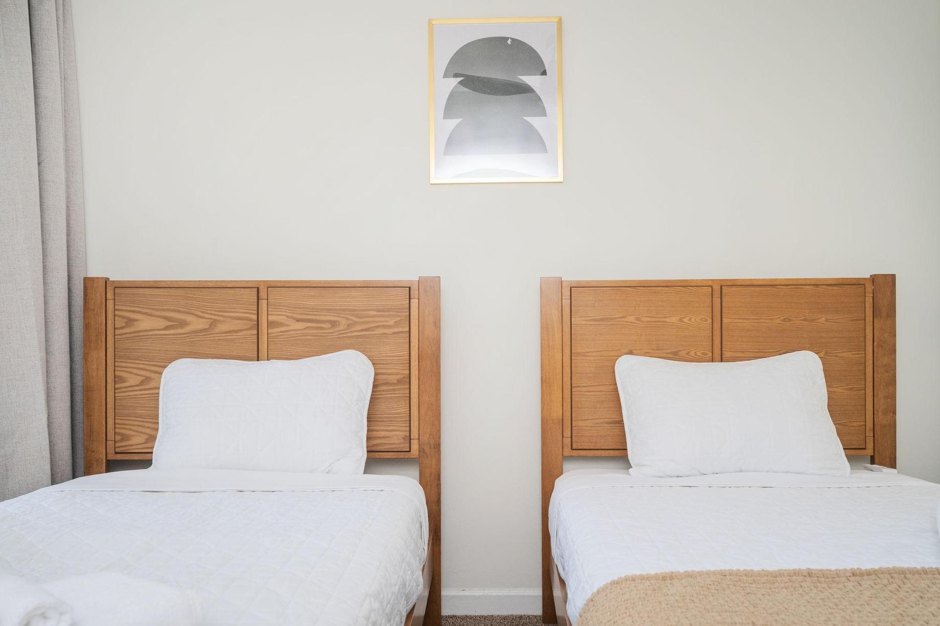 Private bedroom with two full-sized beds, ceiling light, fan, and closet