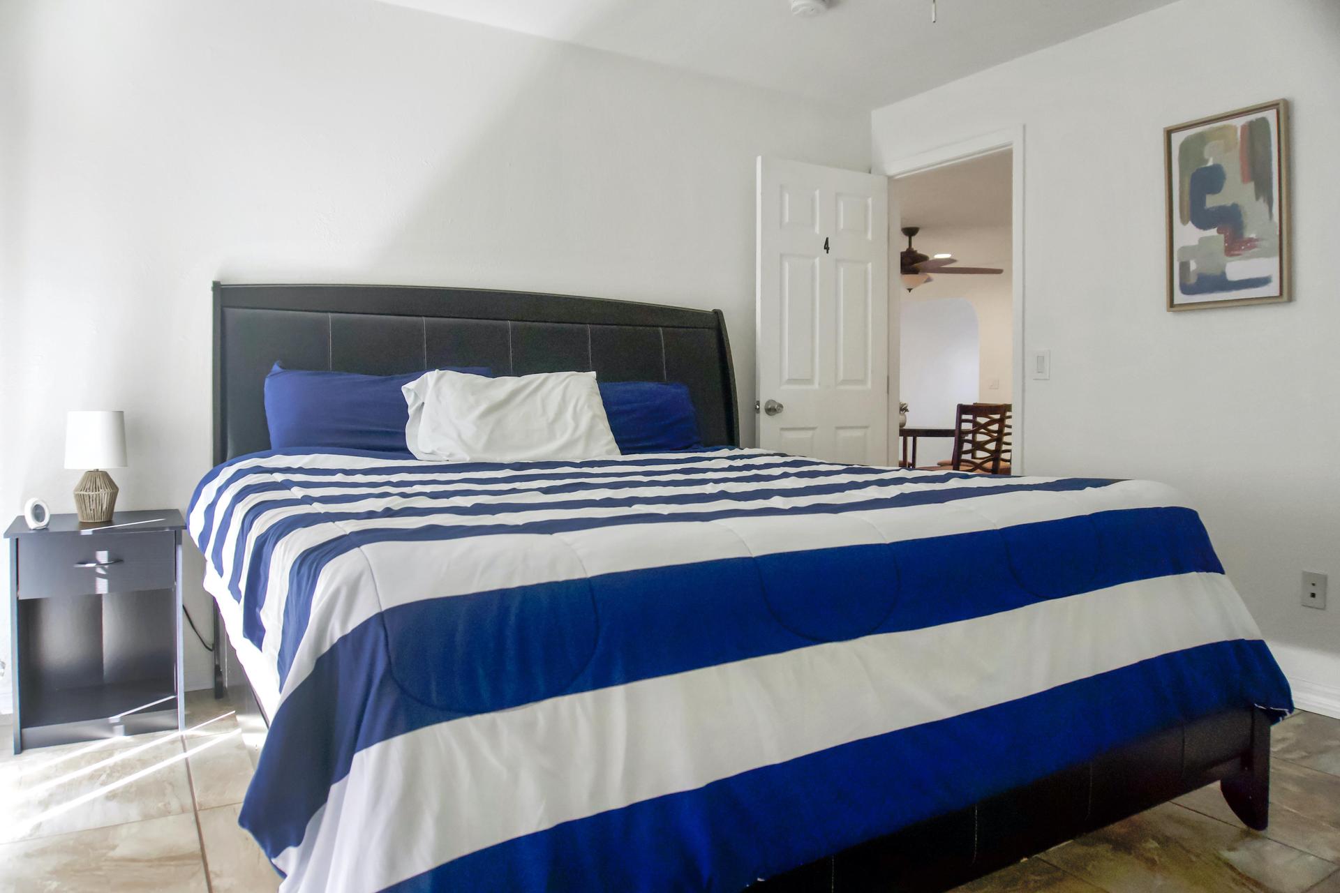 Room with King Size Bed and large sliding door and a convenient private mini-fridge